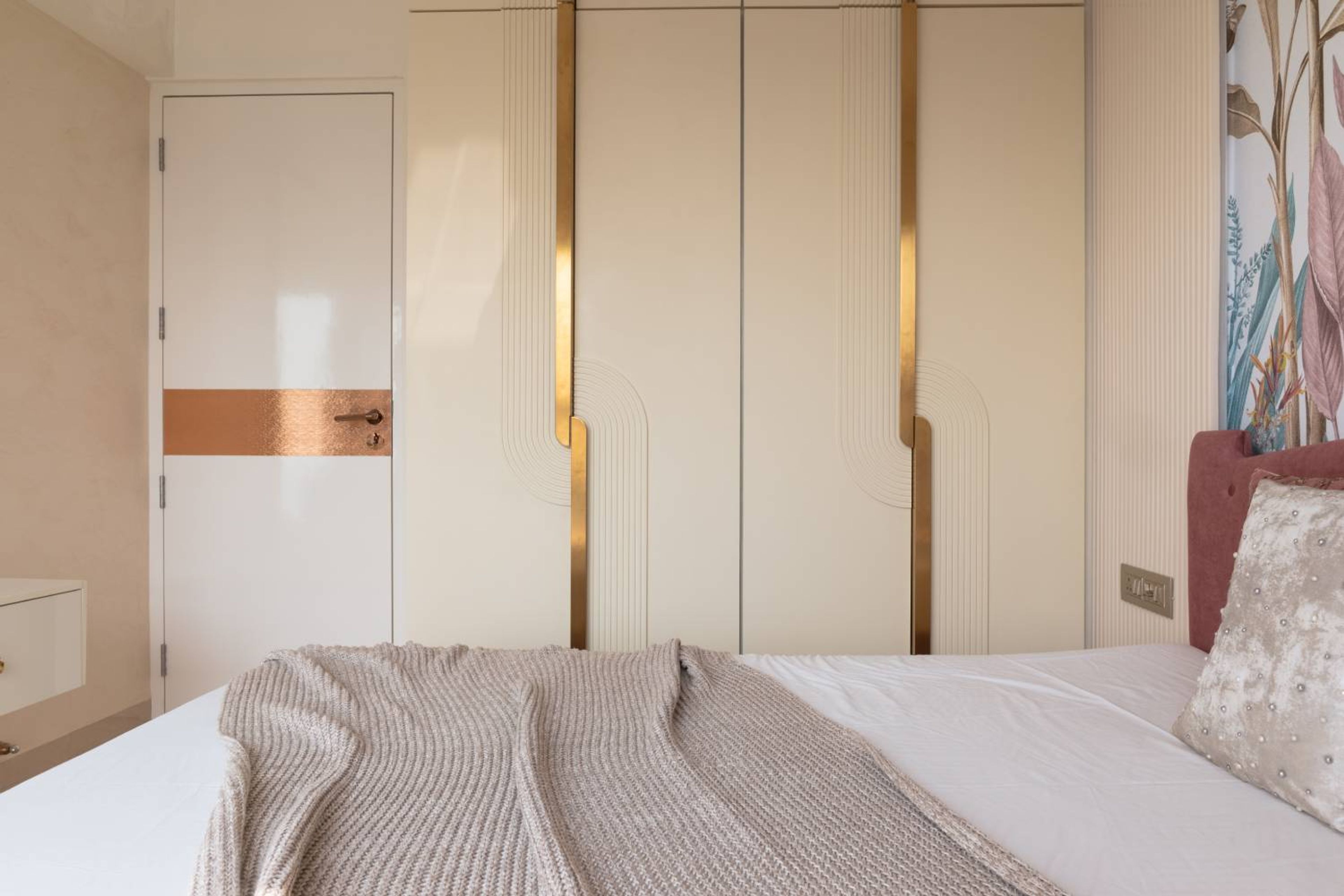 Bedroom Design with Cream-Gold Three-Door Swing Wardrobe and Wall Paneling