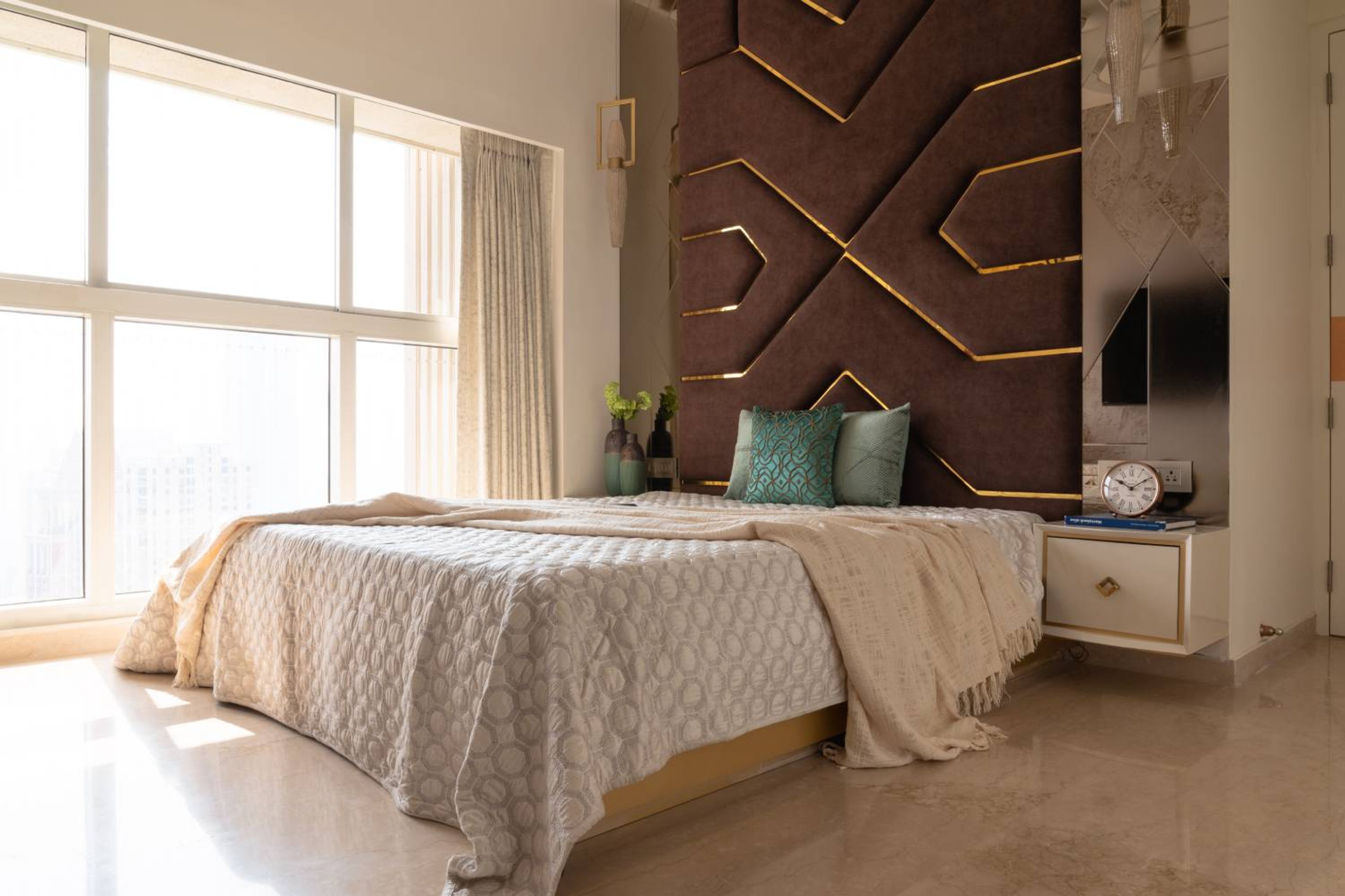 Bedroom Design with Floor-to-Ceiling Windows and Statement Geometric Padded Wall
