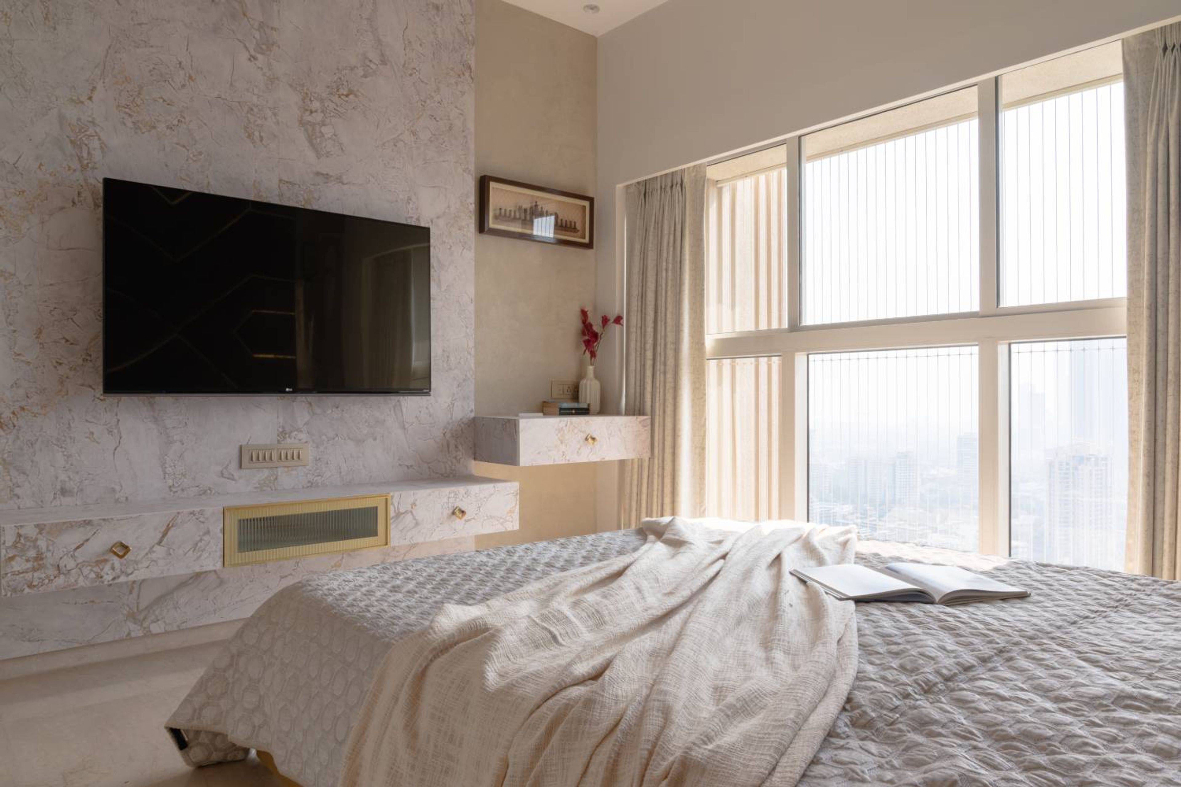 Bedroom Design with Wall-Mounted TV Unit and Marble-Textured Accent Wall