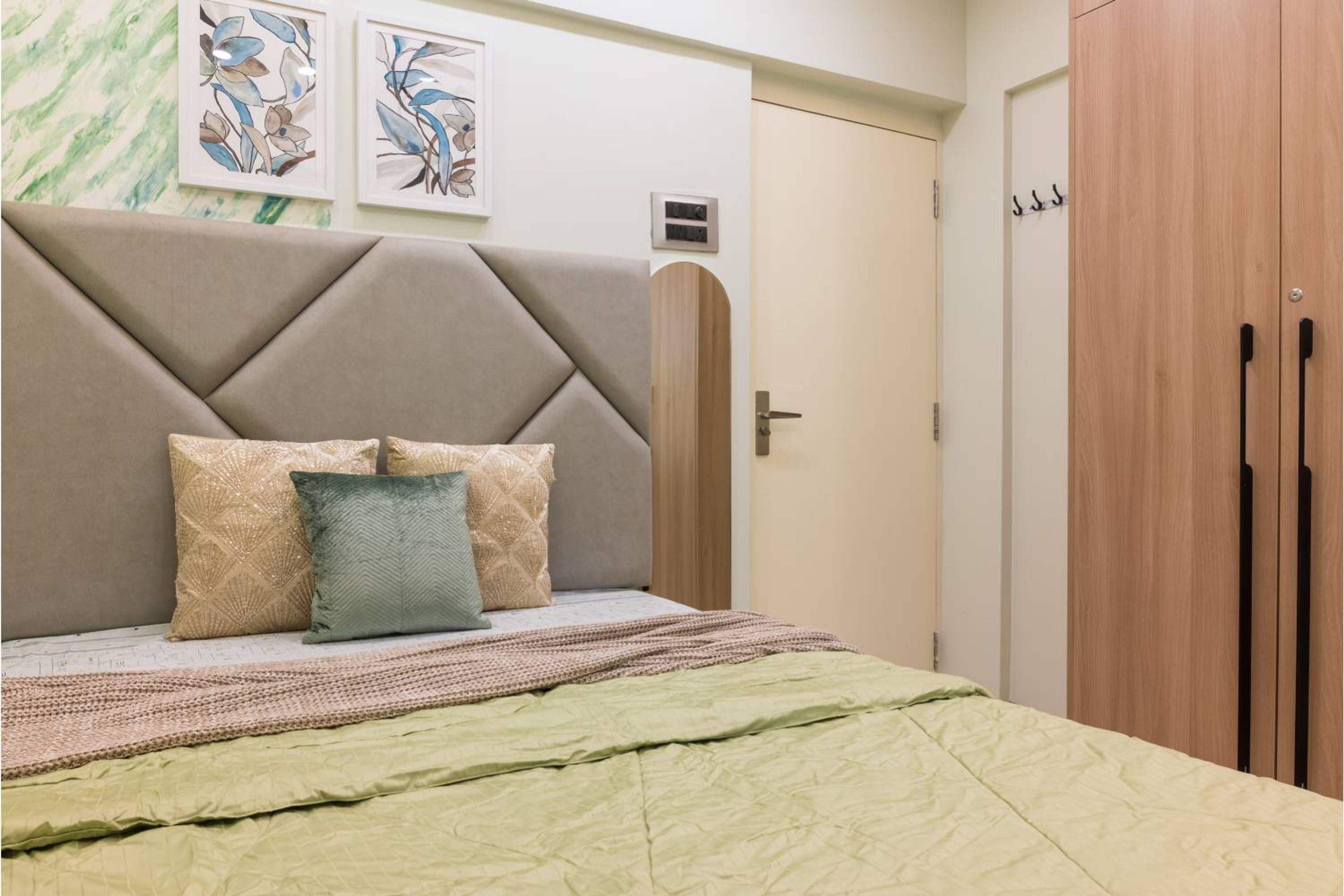 Guest Bedroom Design with Marble Accent Wallpaper and Queen Bed