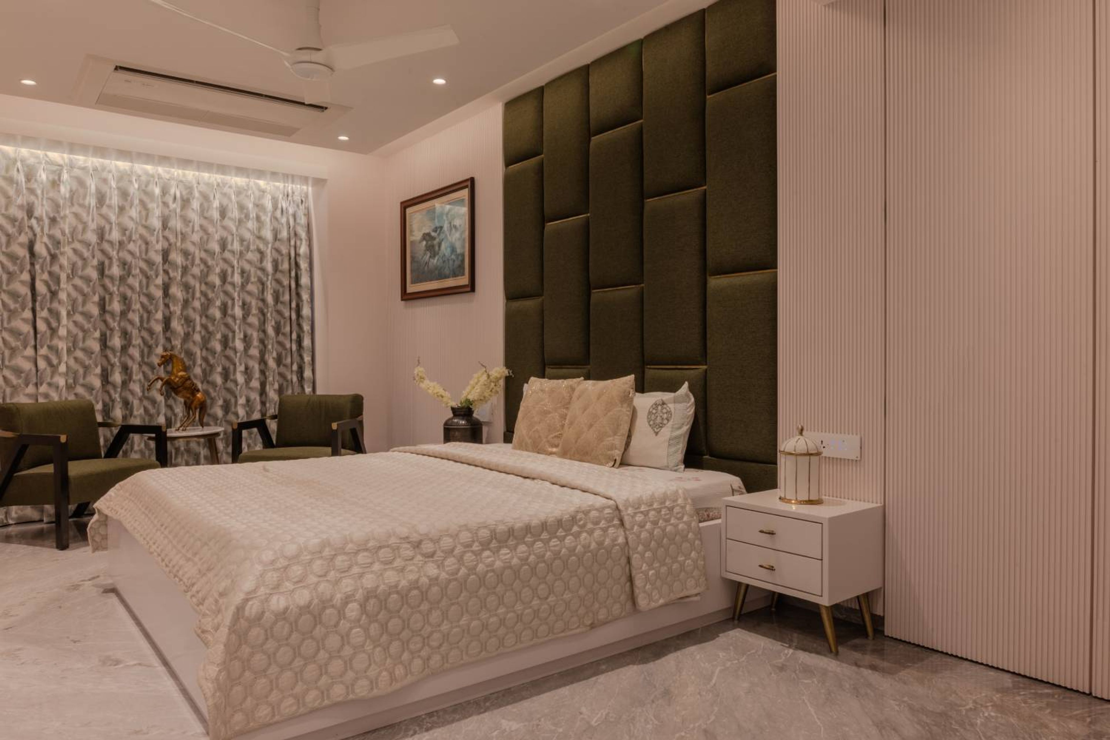 Master Bedroom Design with Green Accent Chair and Round Table