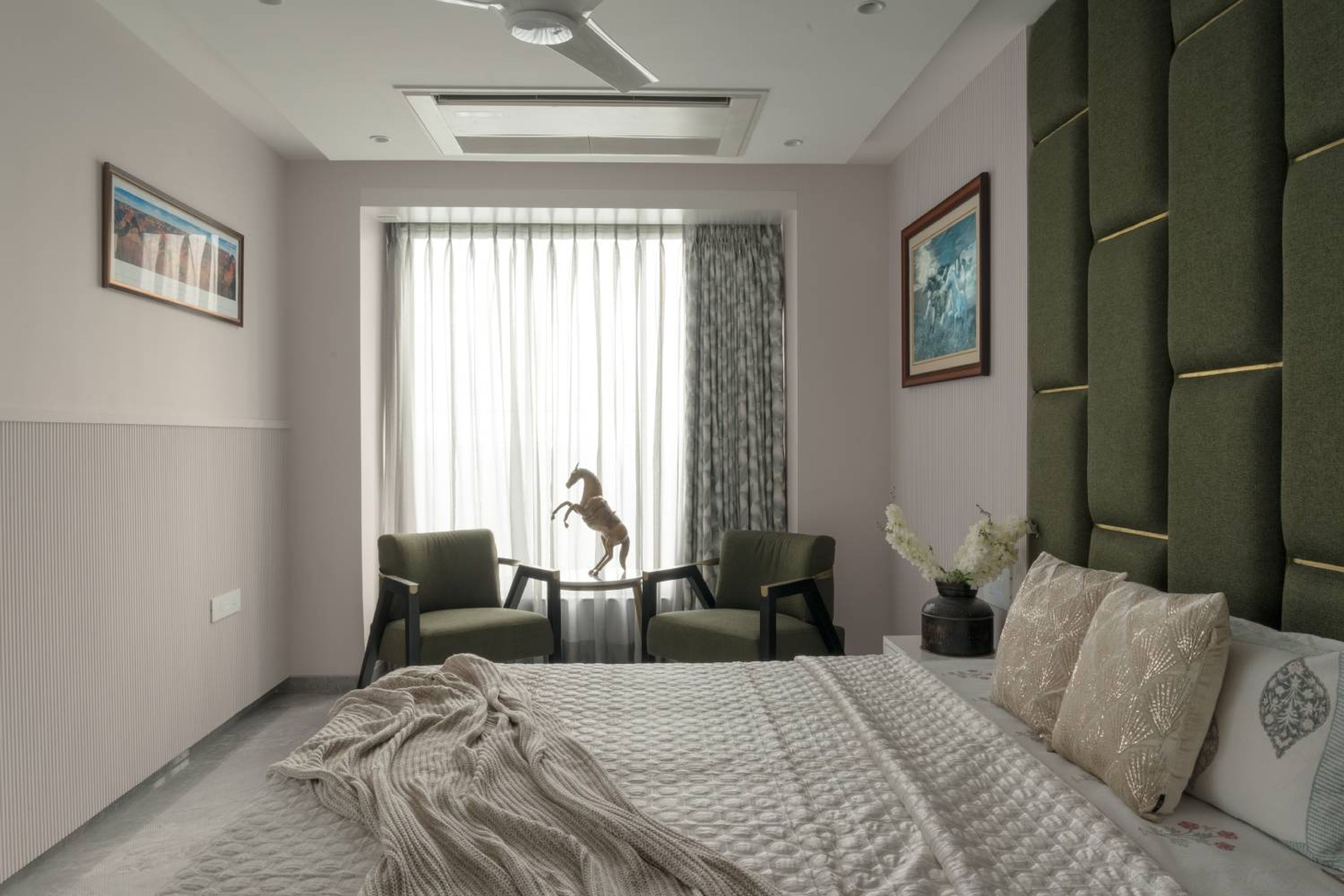 Bedroom design with 2 green accent chairs