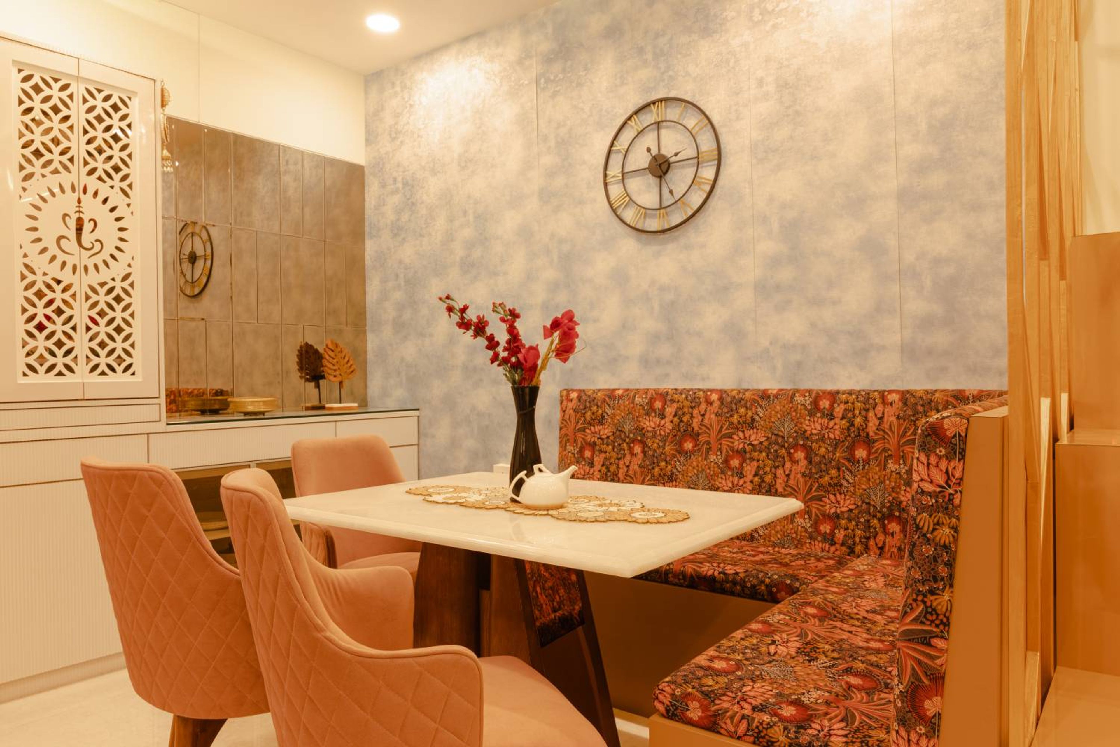Orange dining room design with 3 chairs and L-shaped floral seating bench