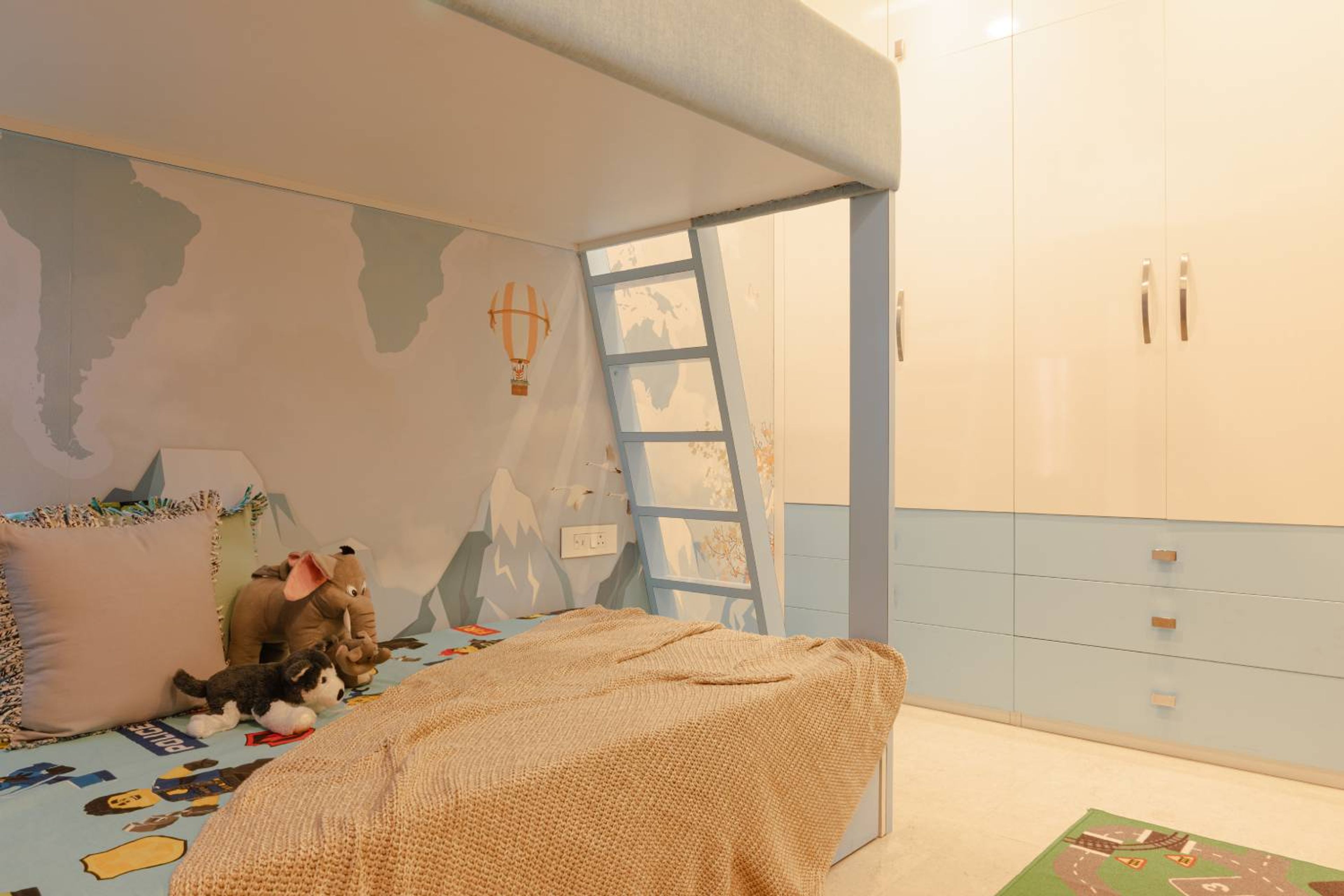 Kids bedroom design with blue bunk bed and 4-door blue and white swing wardrobe
