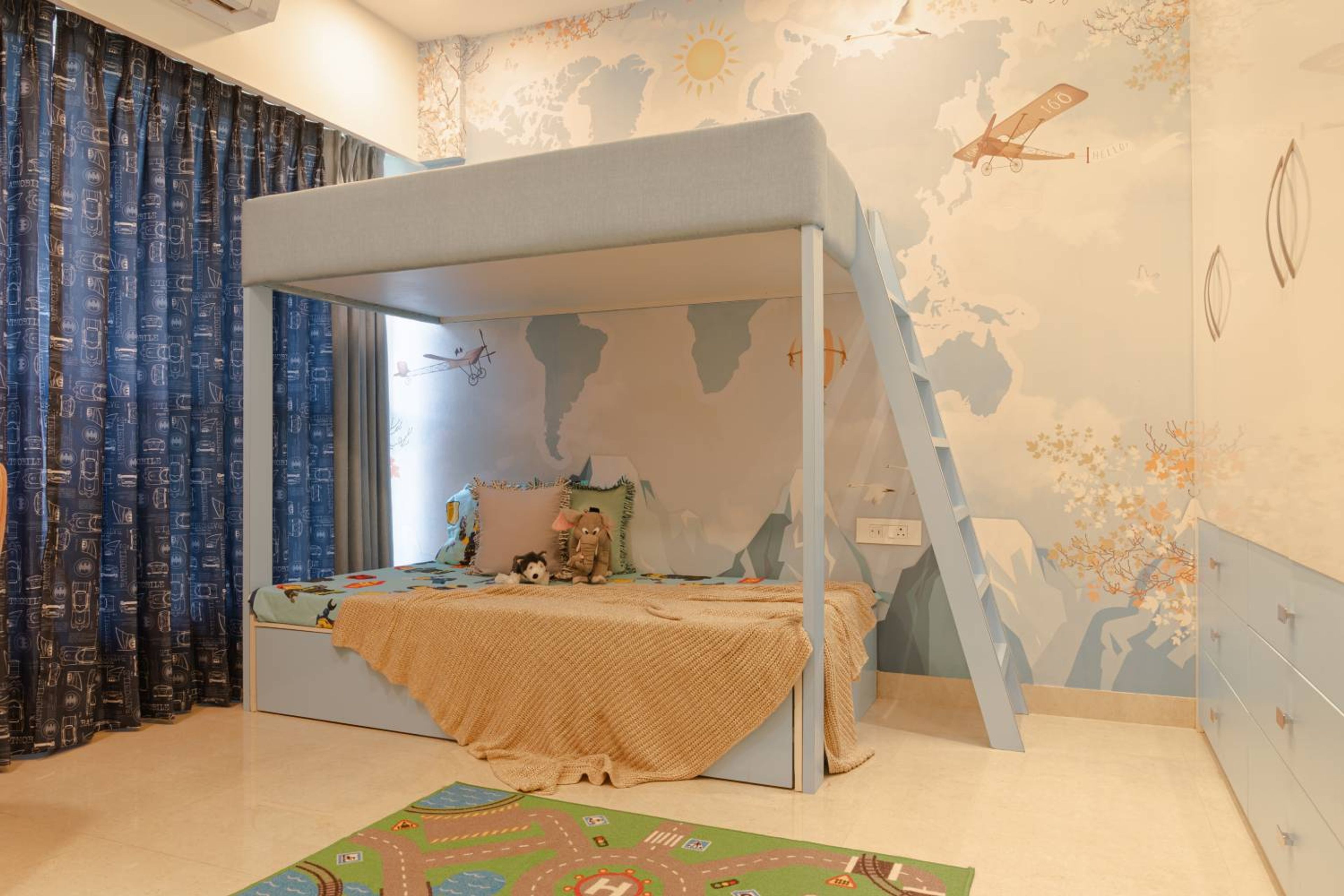 Kids bedroom design with blue bunk bed and map and airplane themed wall