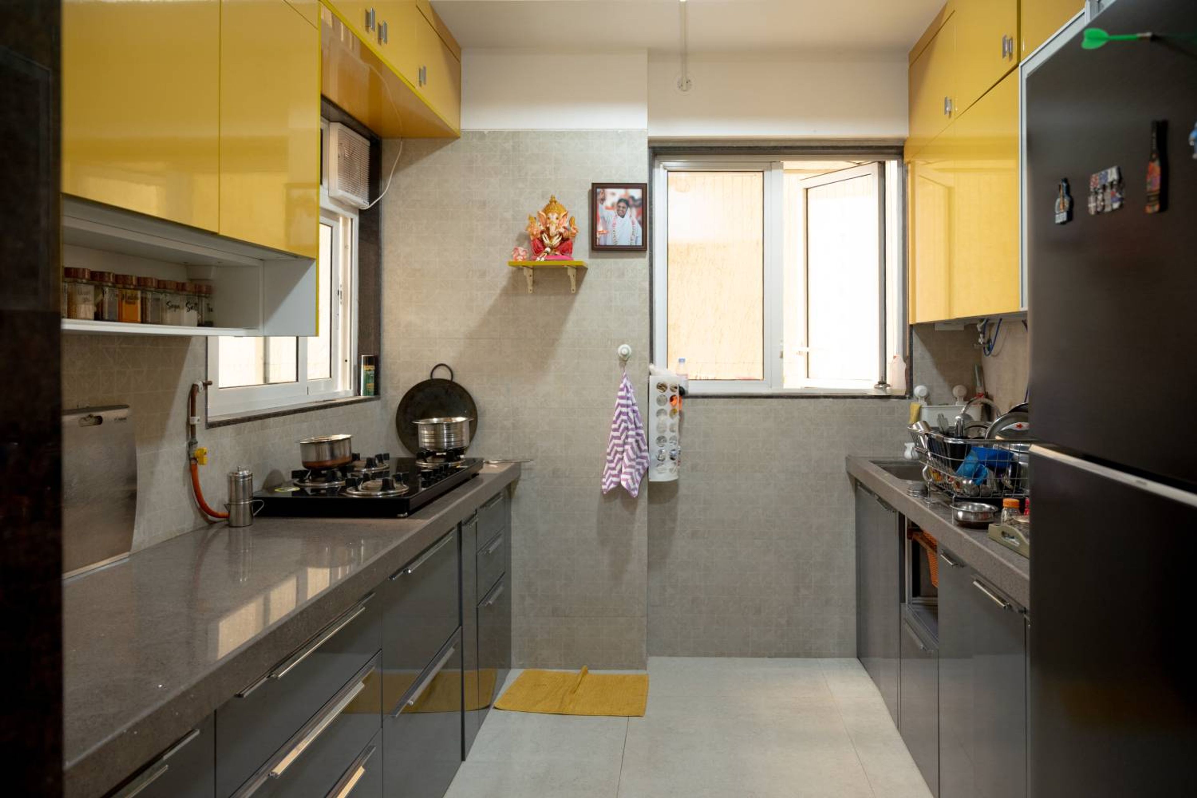 Parallel kitchen design with yellow and grey units