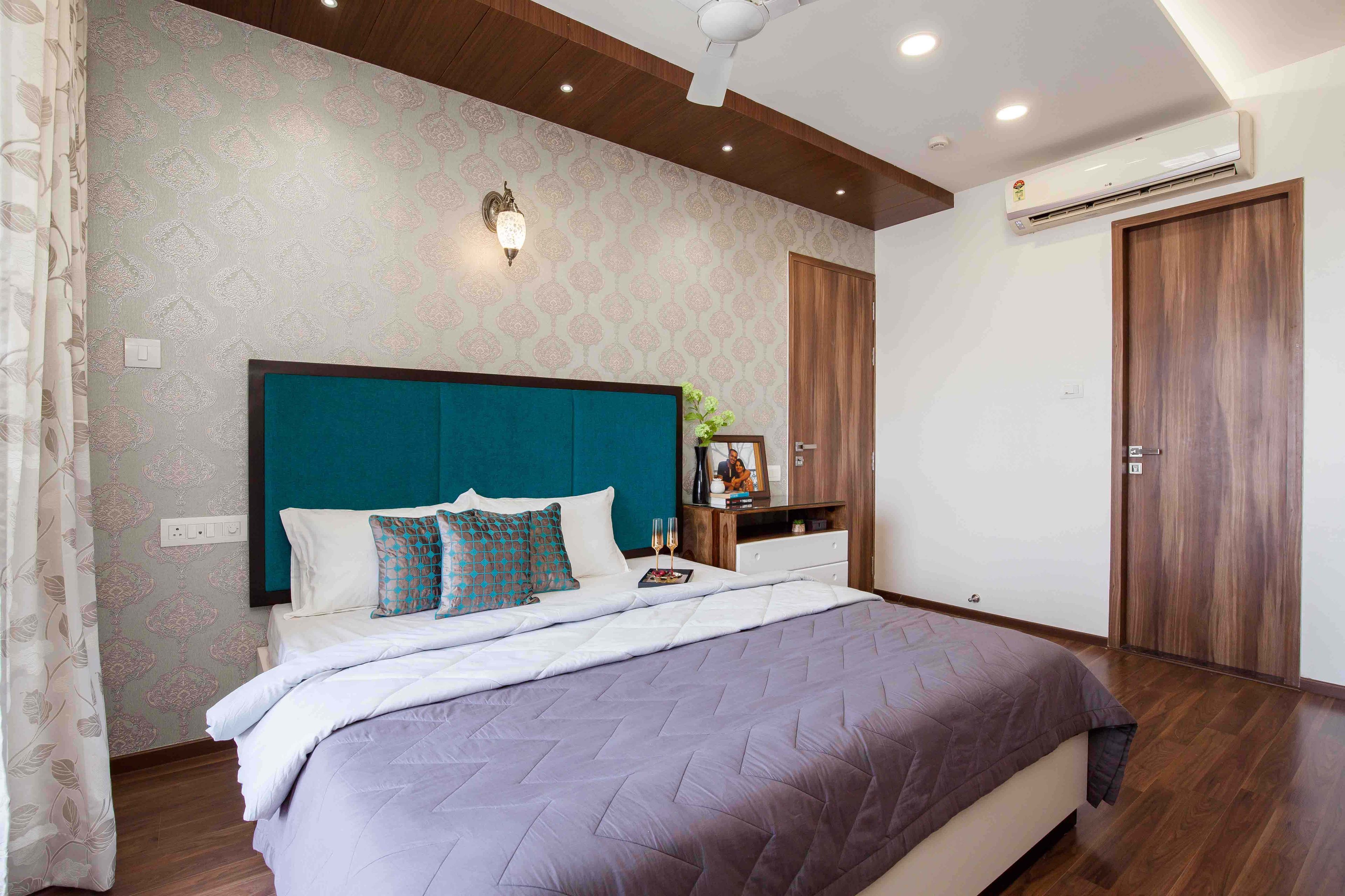 Master Bedroom Design with Pink and Beige Ethnic Motif Wallpaper, Wooden Panel False Ceiling with Spotlights and Wooden Flooring
