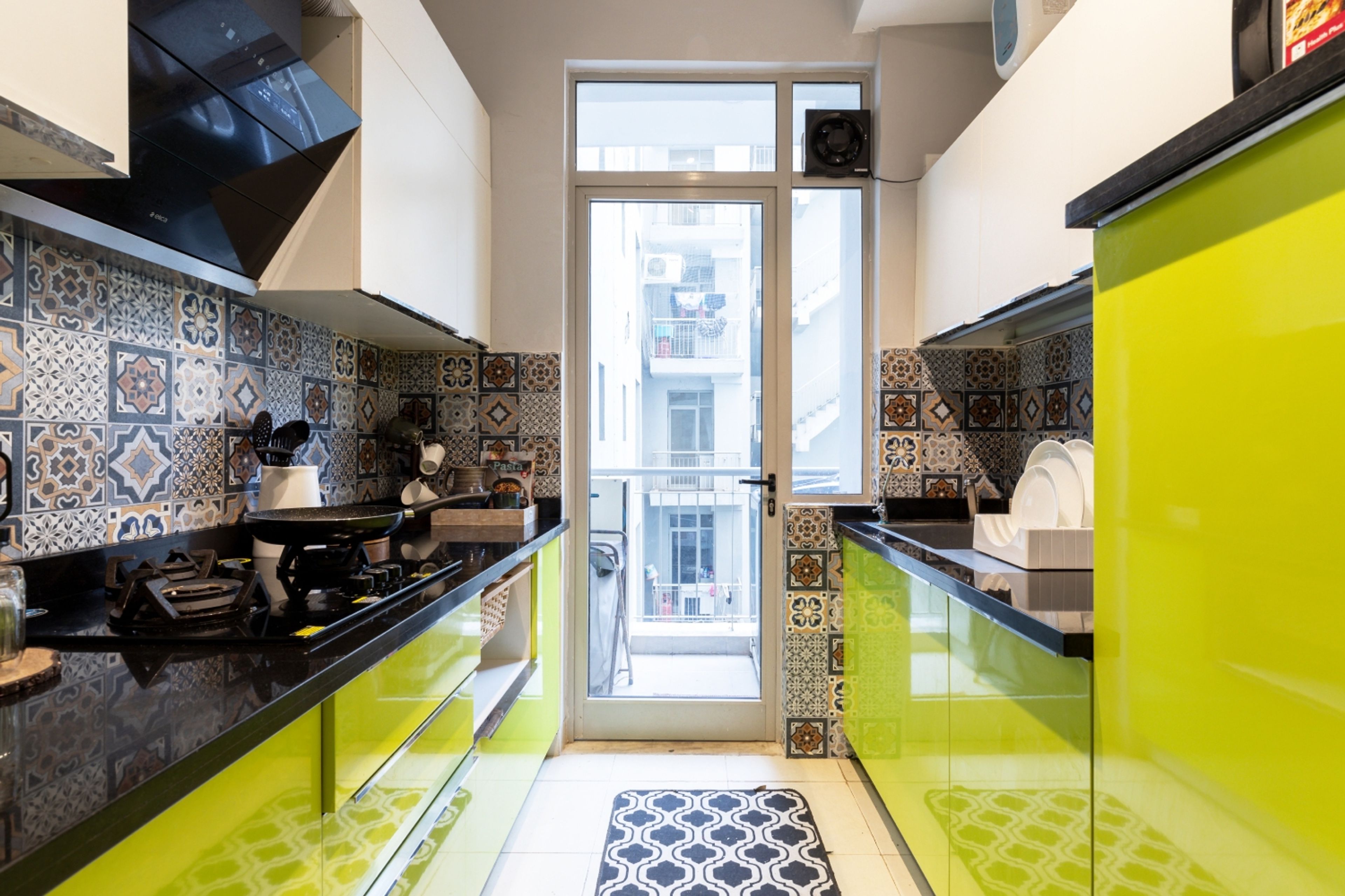 Parallel Modular Kitchen Design with Lime Green and White Units, Moroccan Tiles, and Granite Countertop