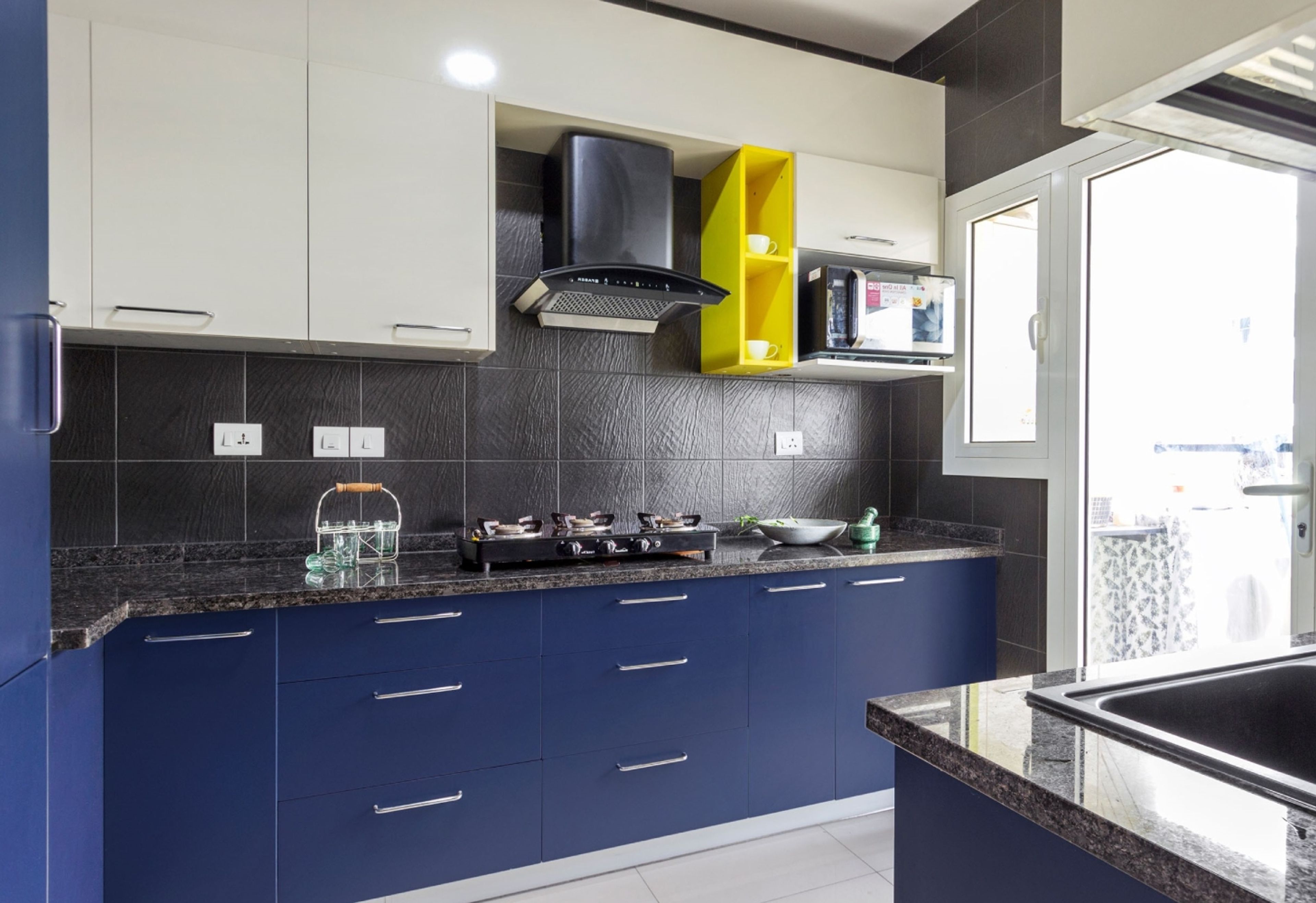 Parallel Kitchen Design with Blue and White Cabinets and Granite Countertops