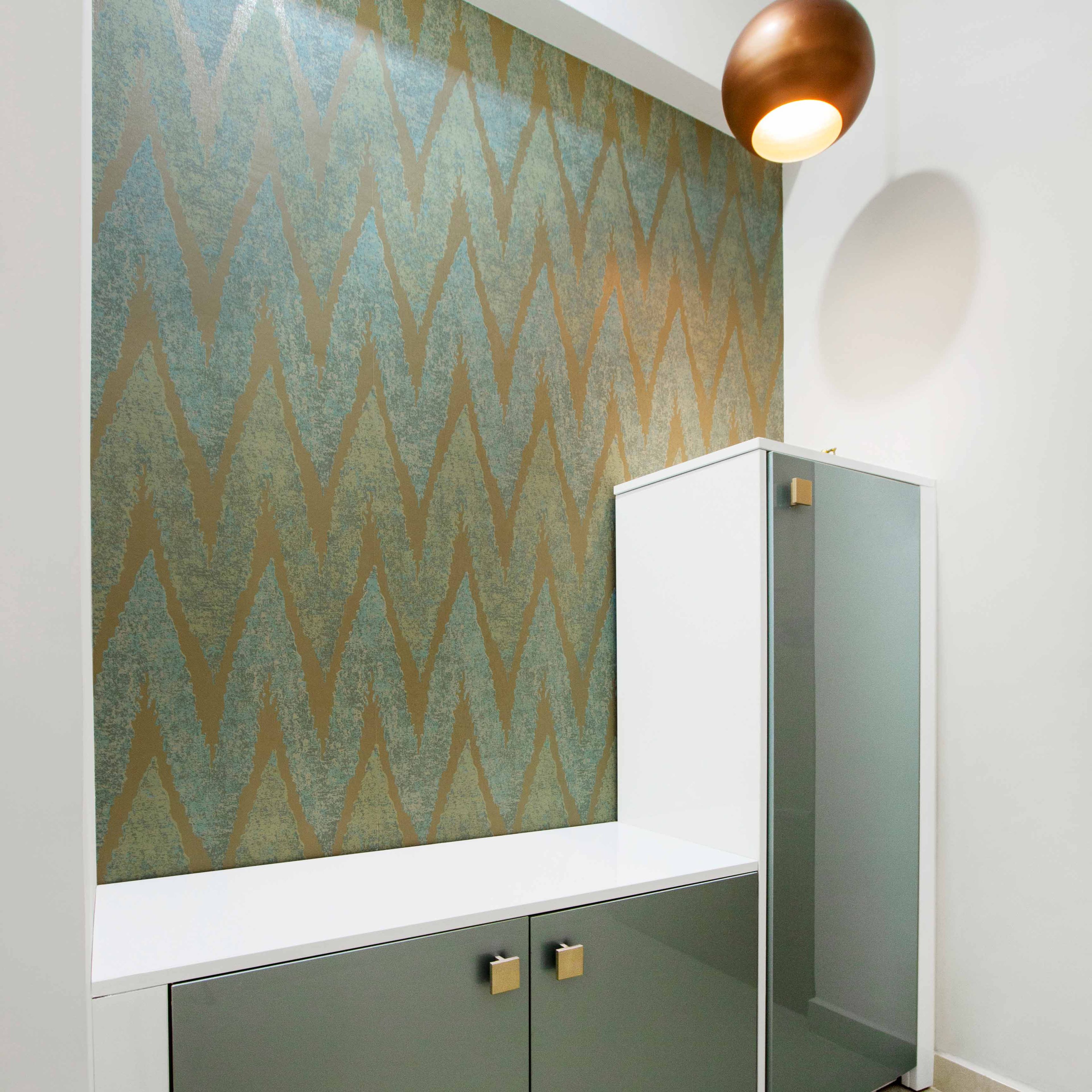 Foyer Design with Green and Golden Patterned Wallpaper and 2 Shoe Cabinets