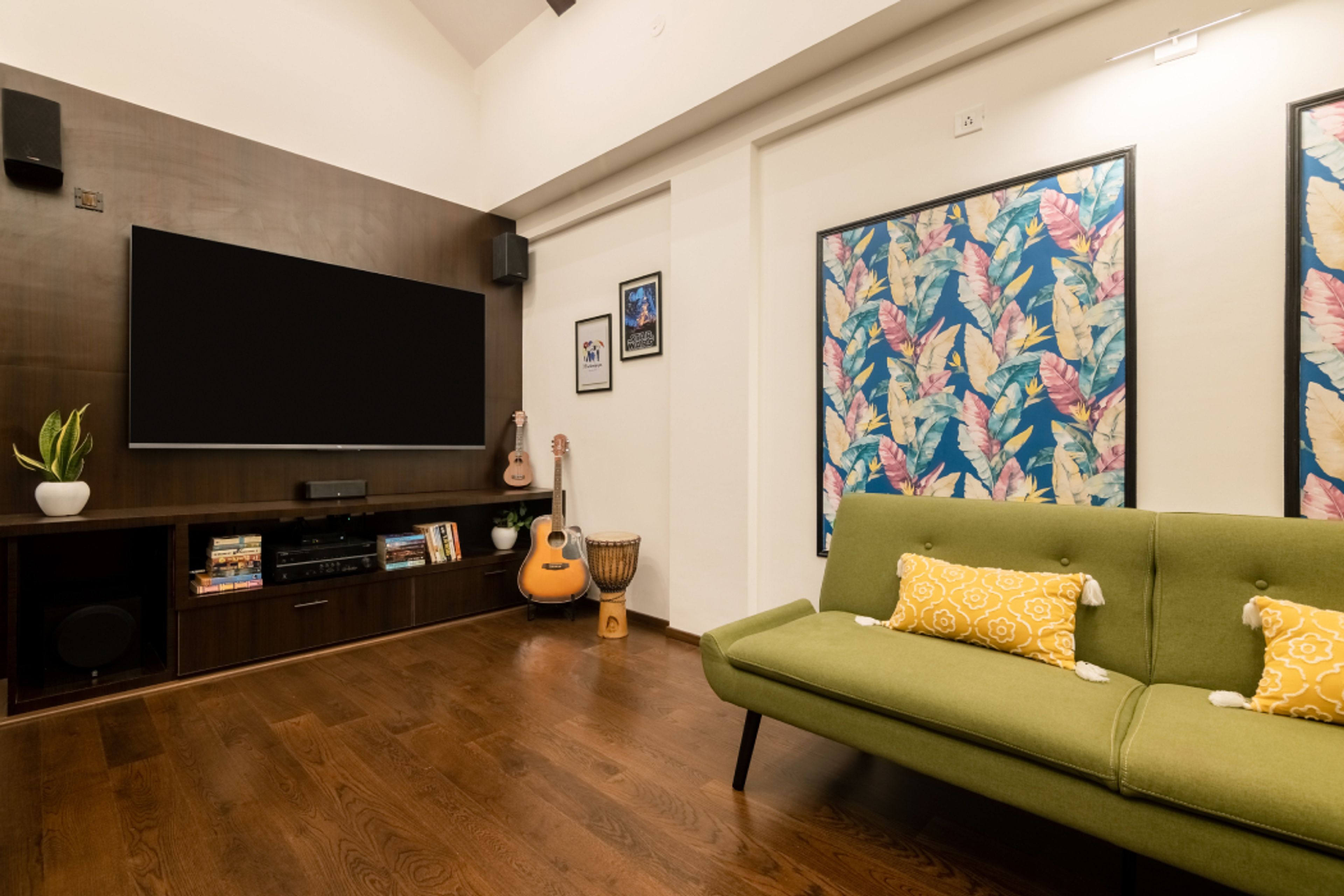 Living Room Design with Green Sofa, Wooden TV Unit and Wooden Flooring