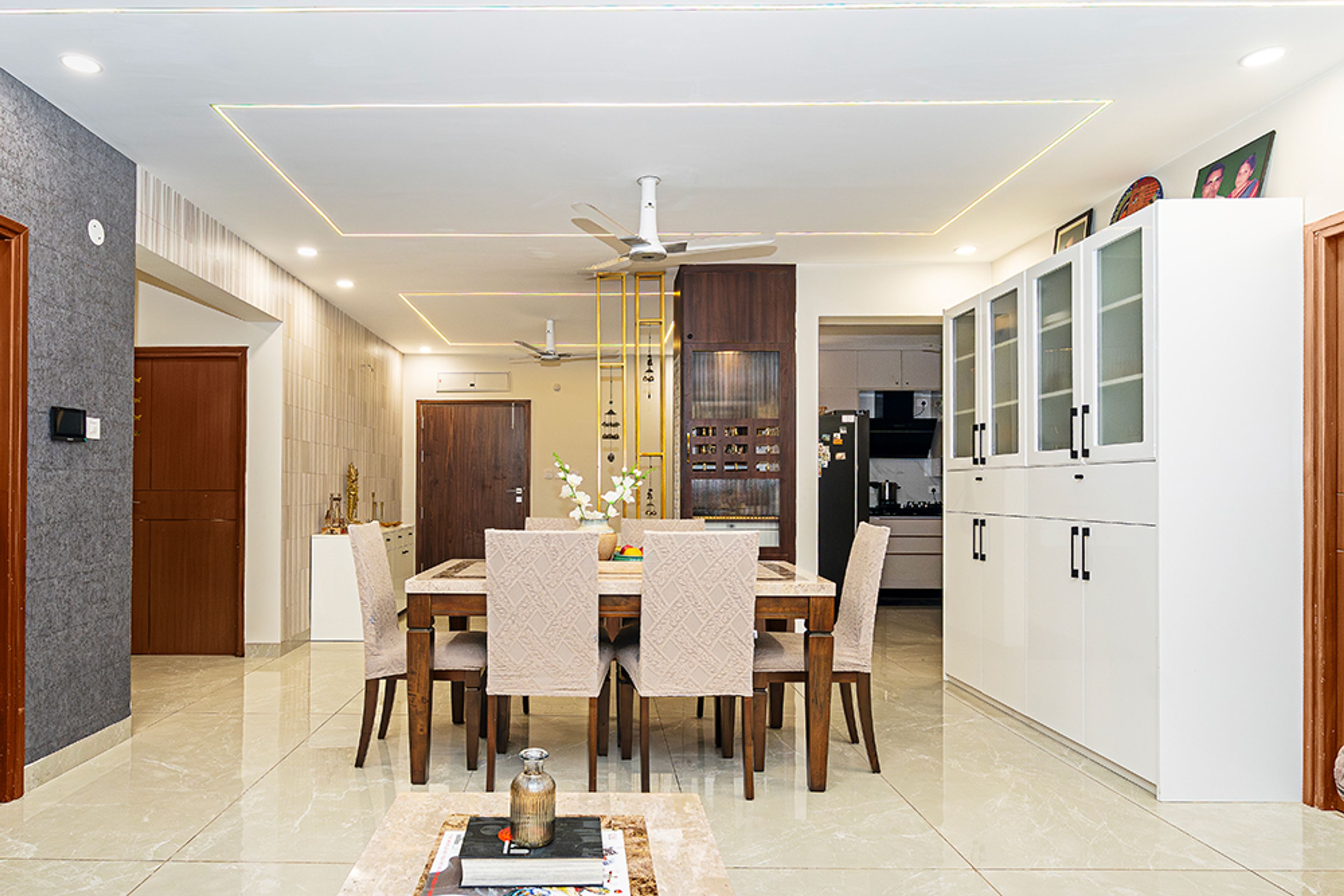 Dining Room Design With Marble Tabletop and Tall Storage Cabinet