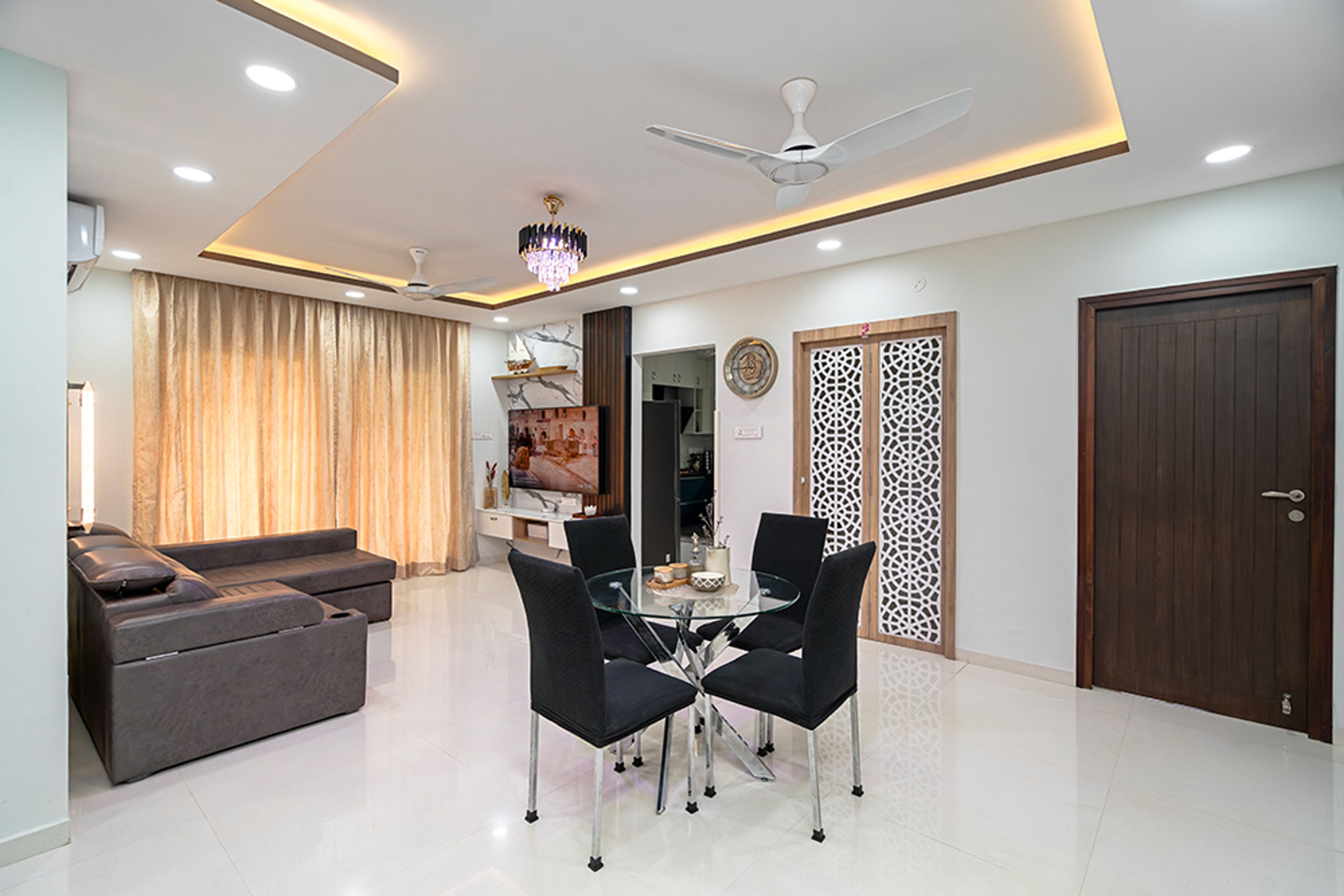Dining Room Design With Sculptural Glass Table and Black Upholstered Chairs