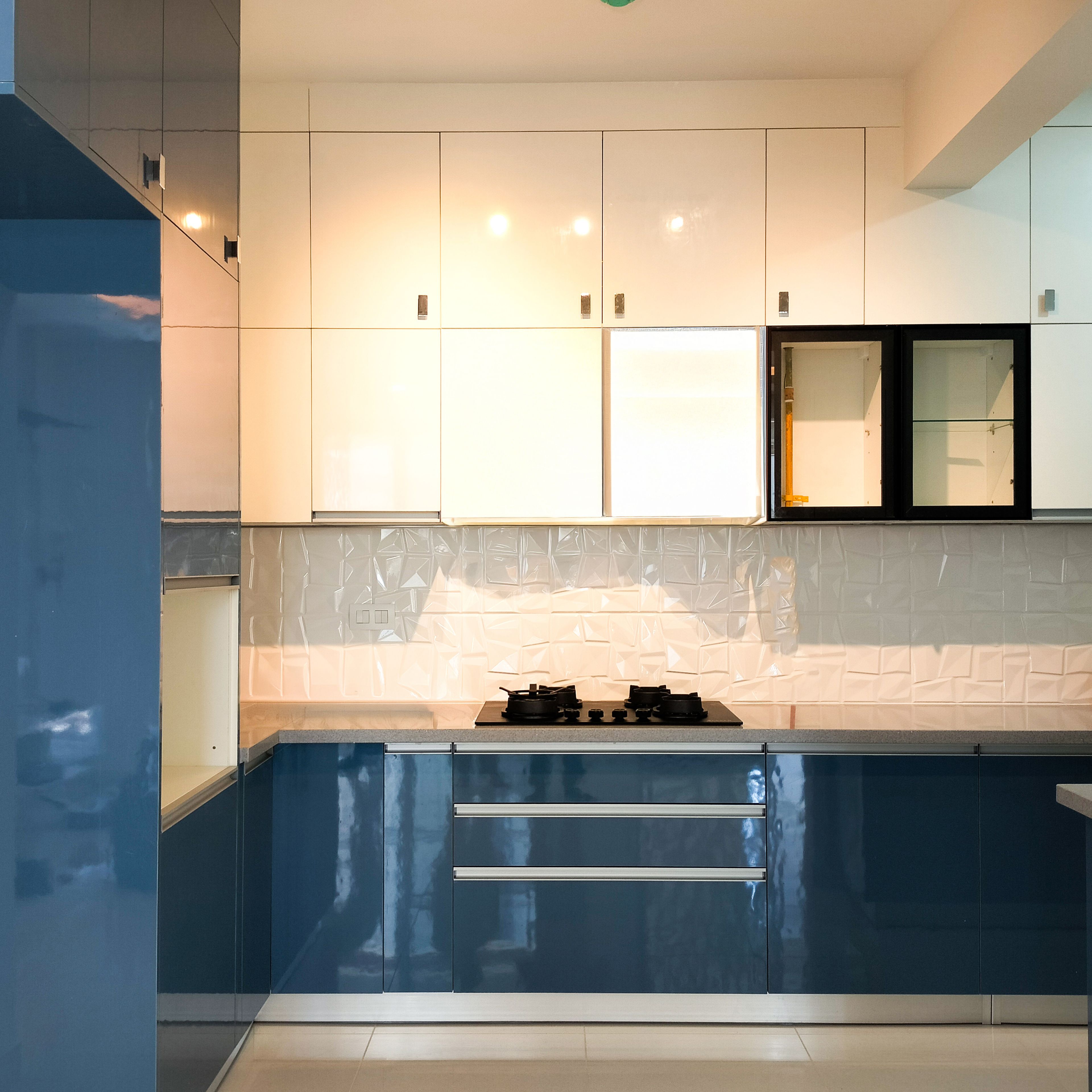 Contemporary L-Shaped Kitchen Design with Blue Cabinets and Marble Countertops
