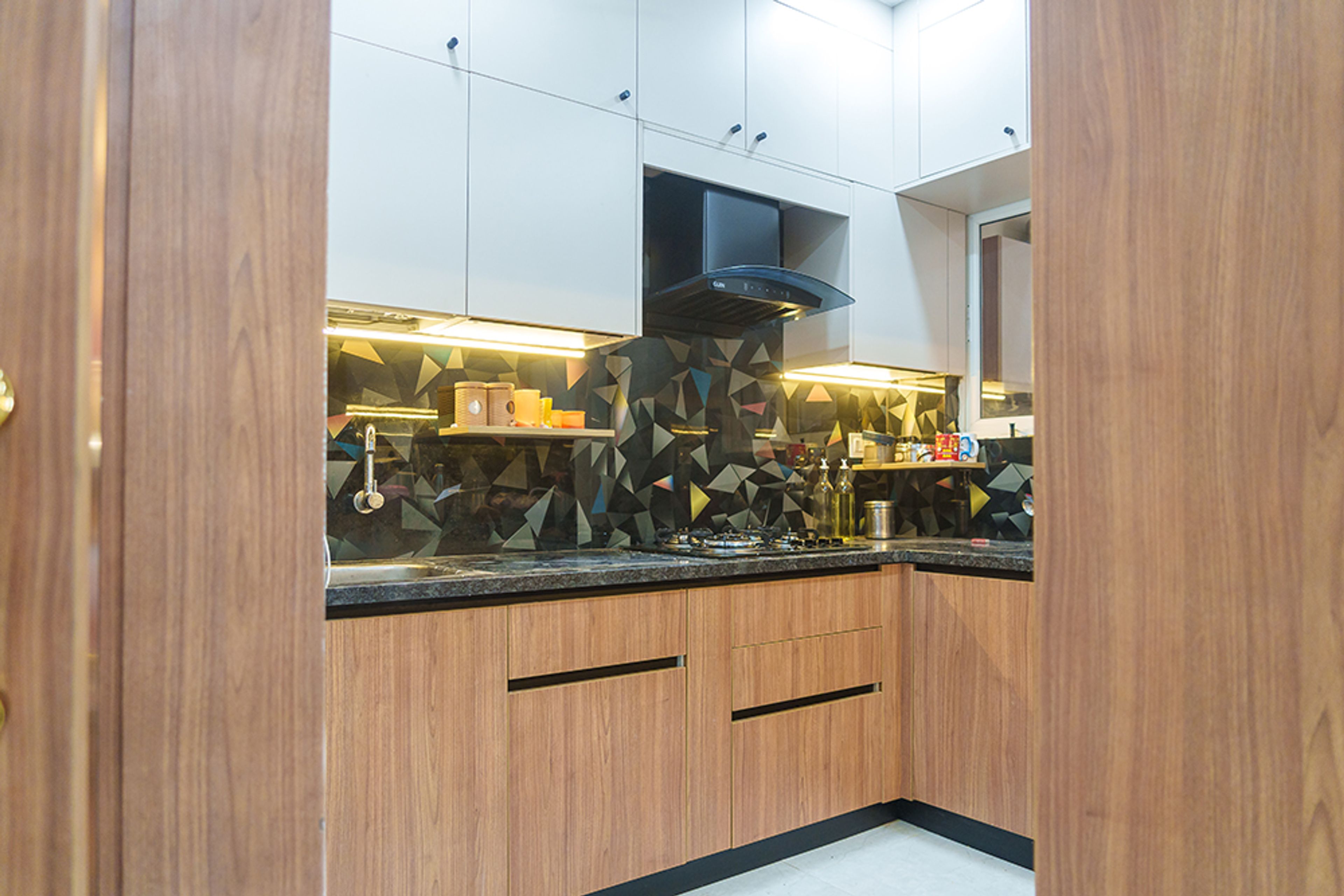 L-Shaped Contemporary Kitchen Design with Walnut Base and Geometric Backsplash
