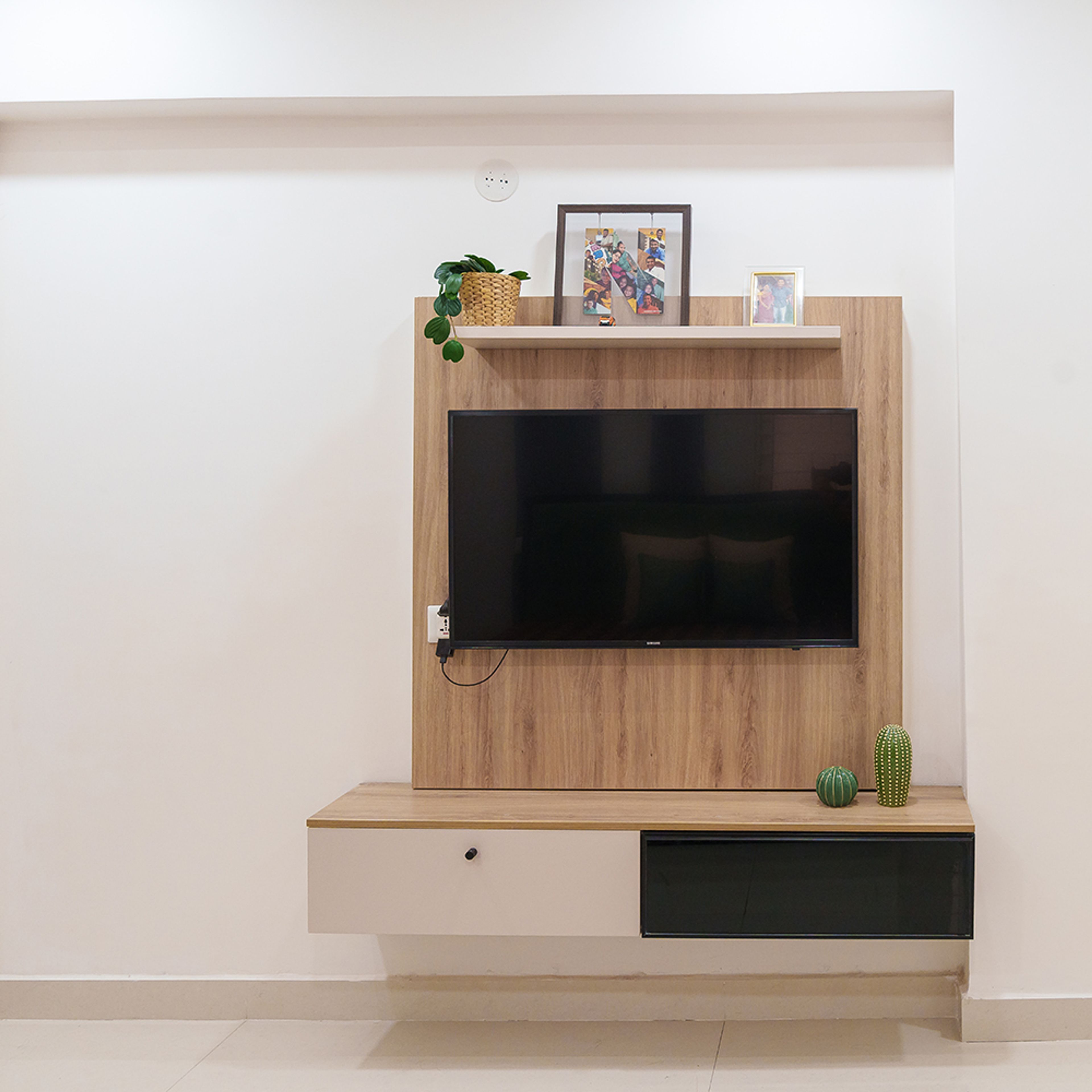 Wall-Mounted Modern TV Unit Design With Shelf and Photo Display