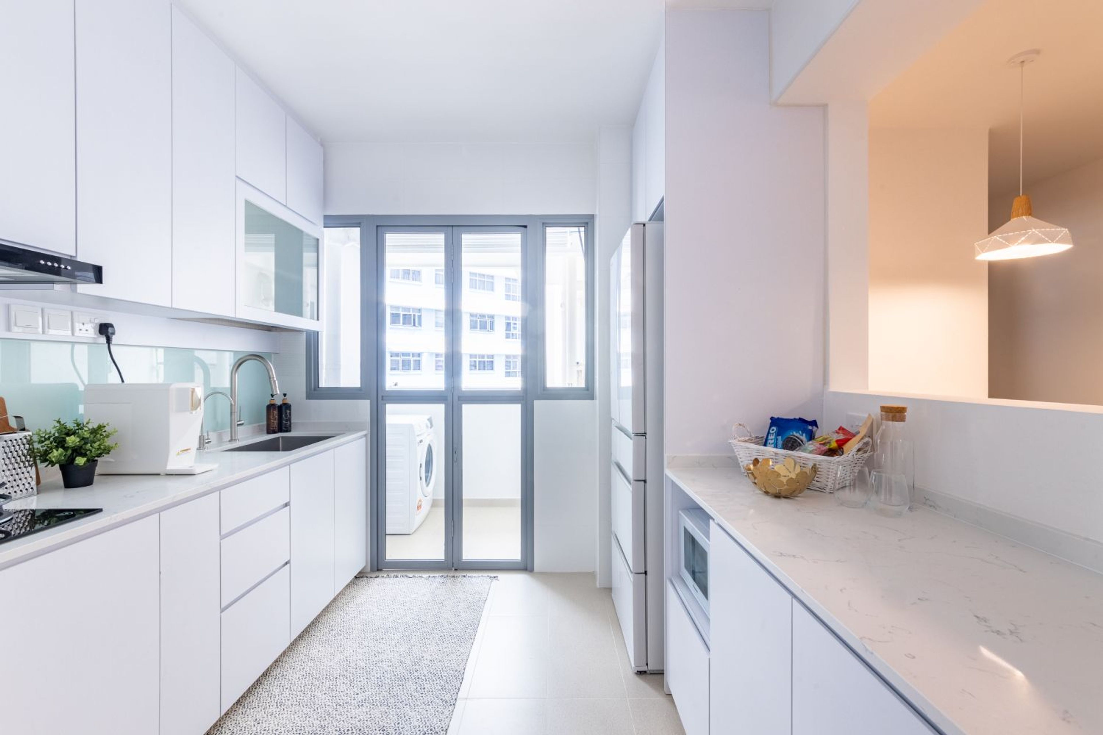 Parallel White Kitchen Design With Light Sea-Green Glossy Backsplash - Livspace