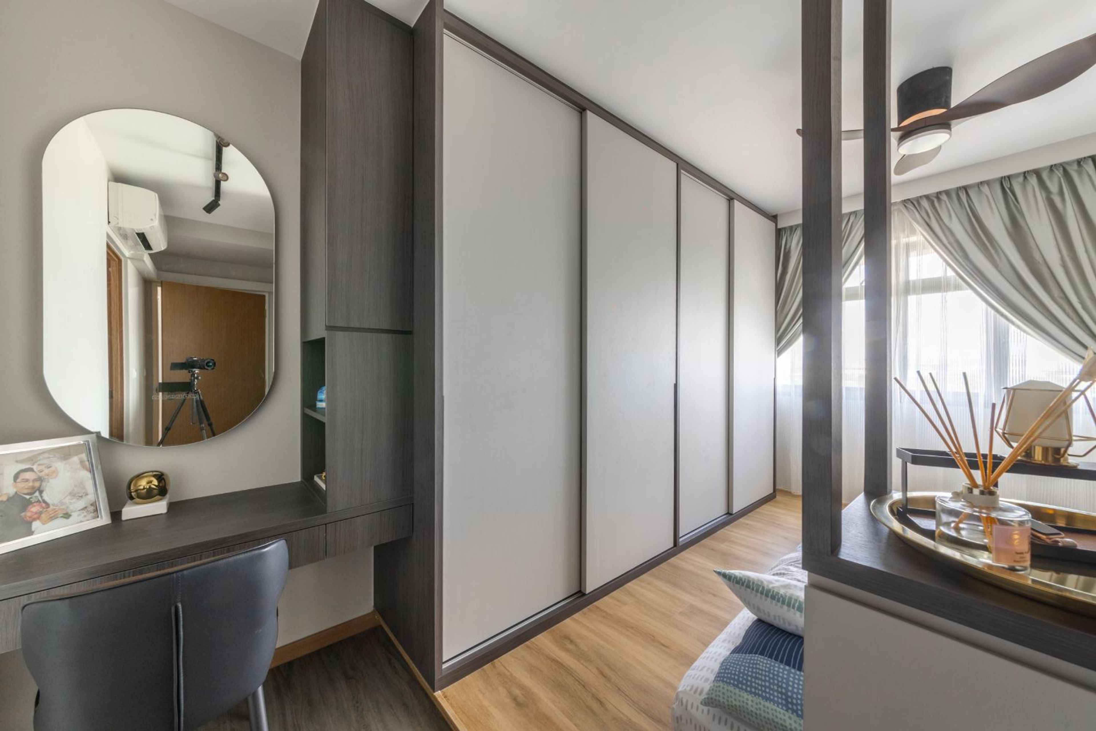 4-Door Grey Sliding Wardrobe Design With Integrated Dressing Unit And Oval Mirror - Livspace