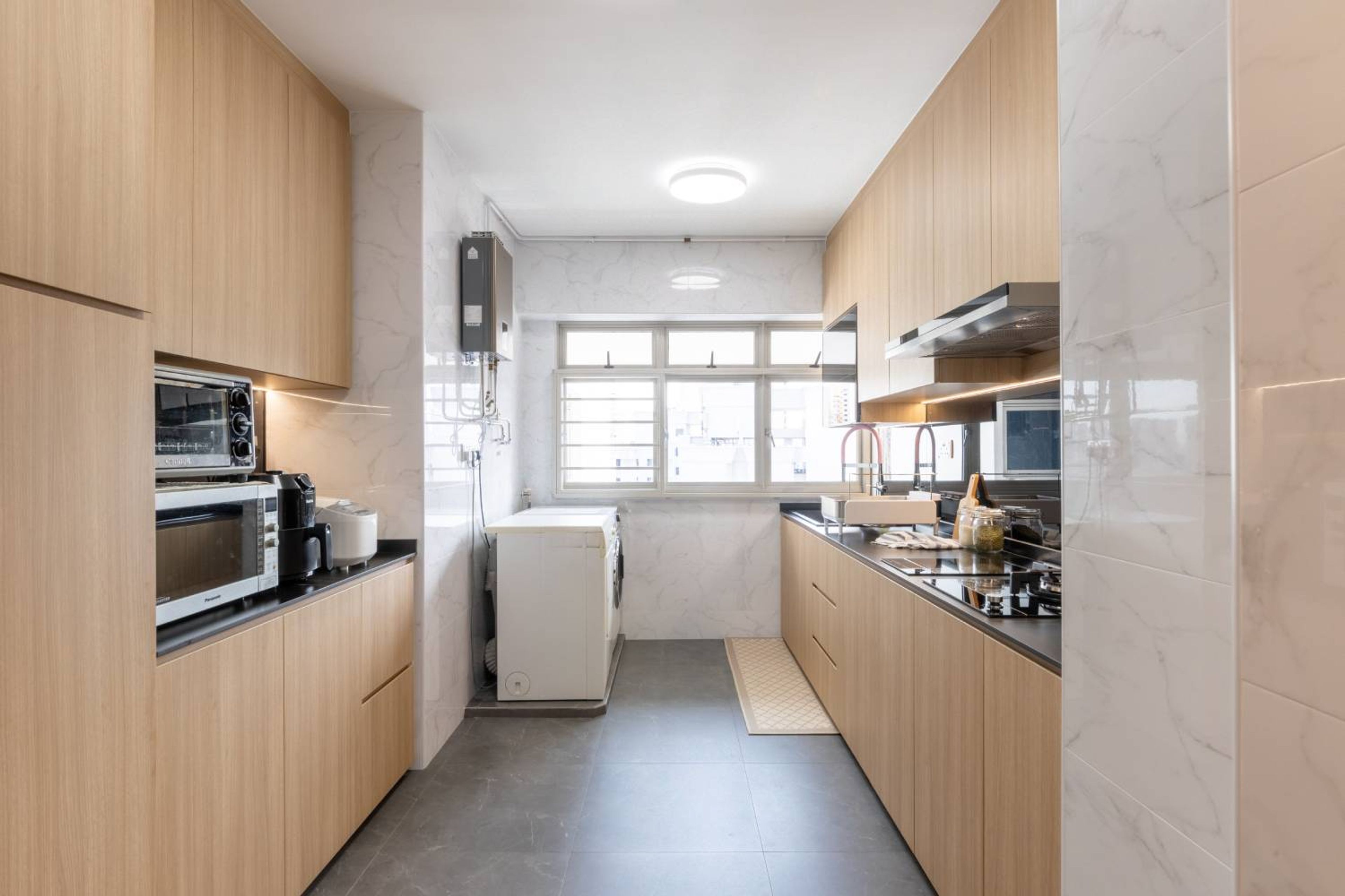 Brown Parallel Kitchen Design With Lacquered Glass Backsplash - Livspace