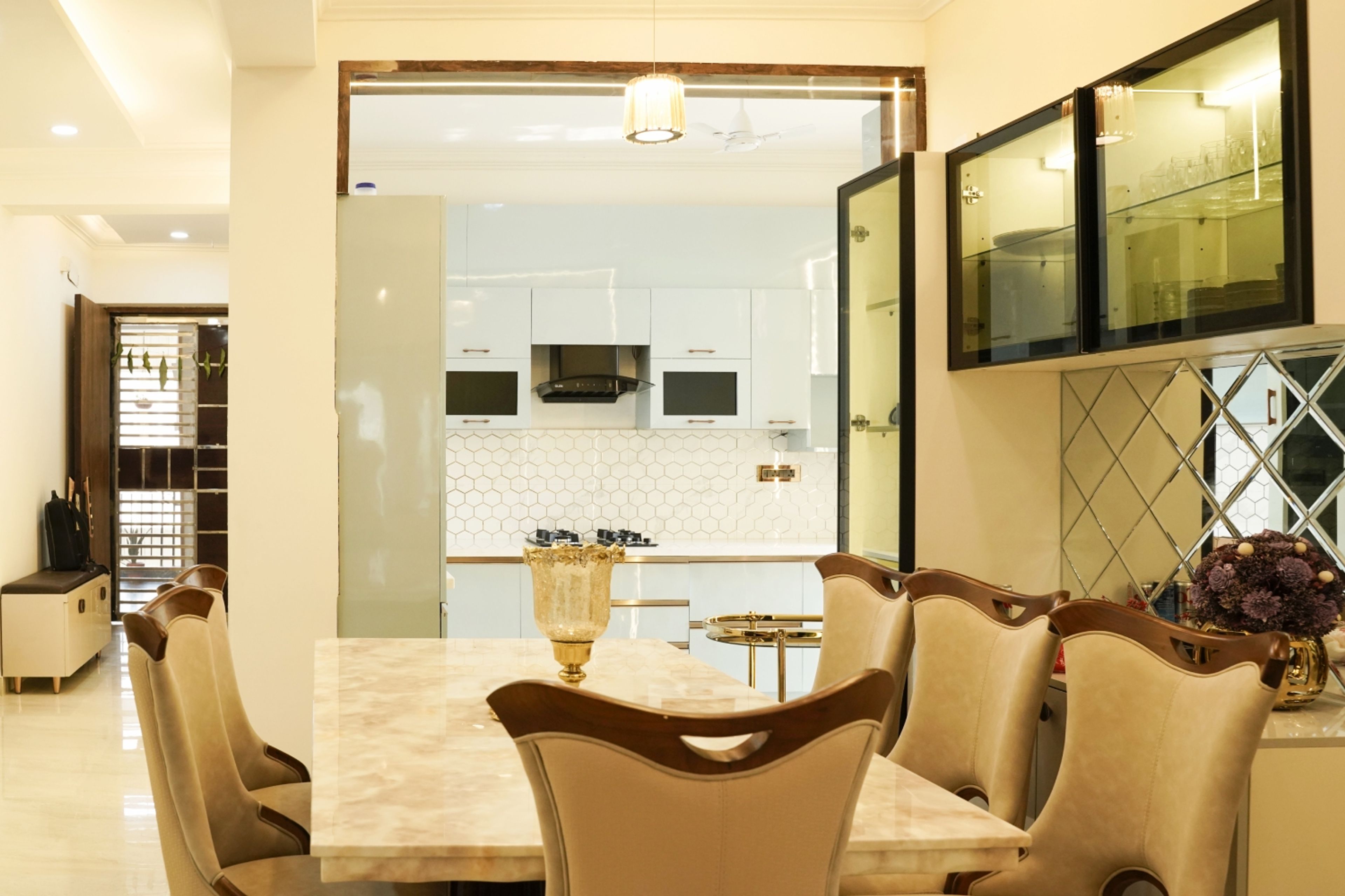 Dining Room Design with Carved Chairs and Glass Storage