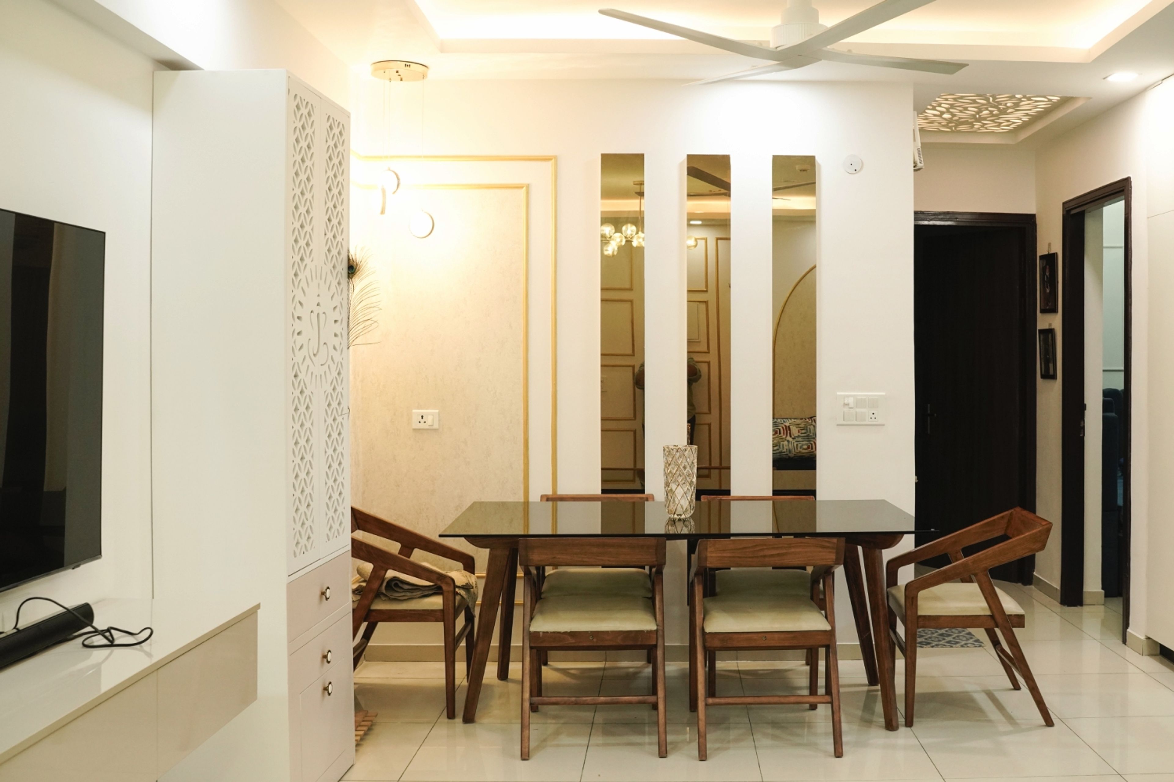 Dining Room Design with Black Glass Table and Wooden Chairs