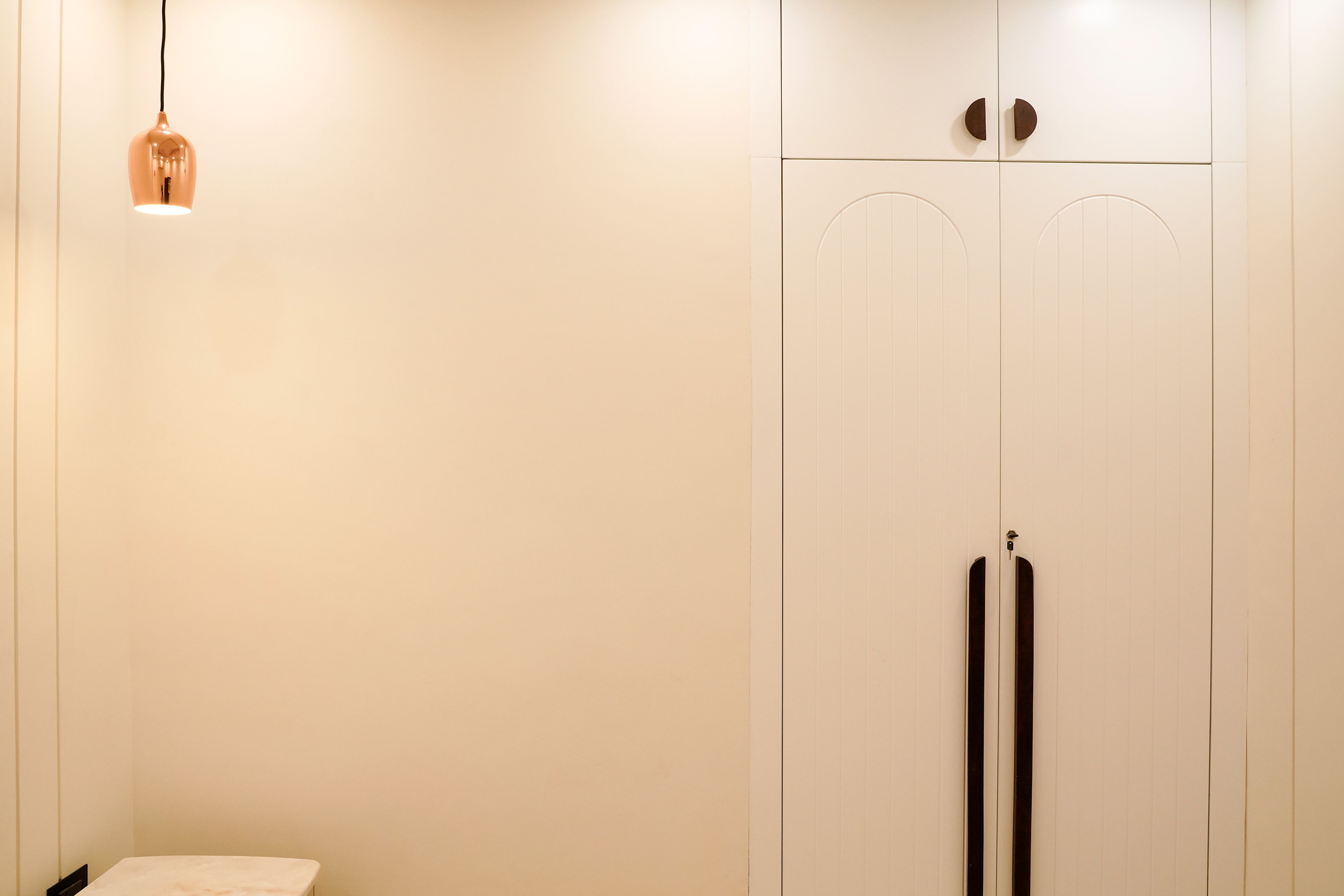 Guest Bedroom Design with Cream Bed and Arched White Wardrobe