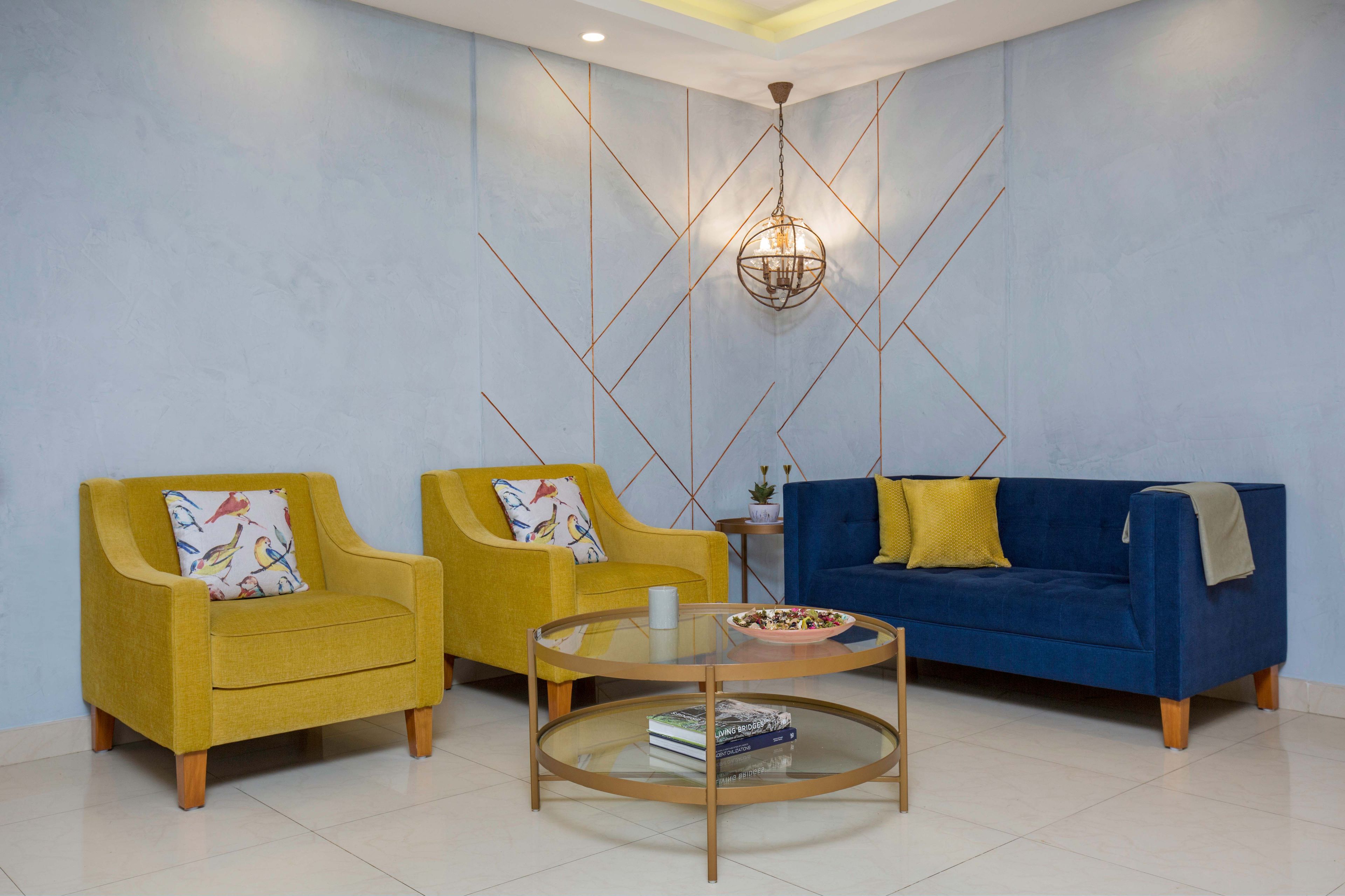 Contemporary Living Room Design With Mustard Chairs and Navy Blue Sofa