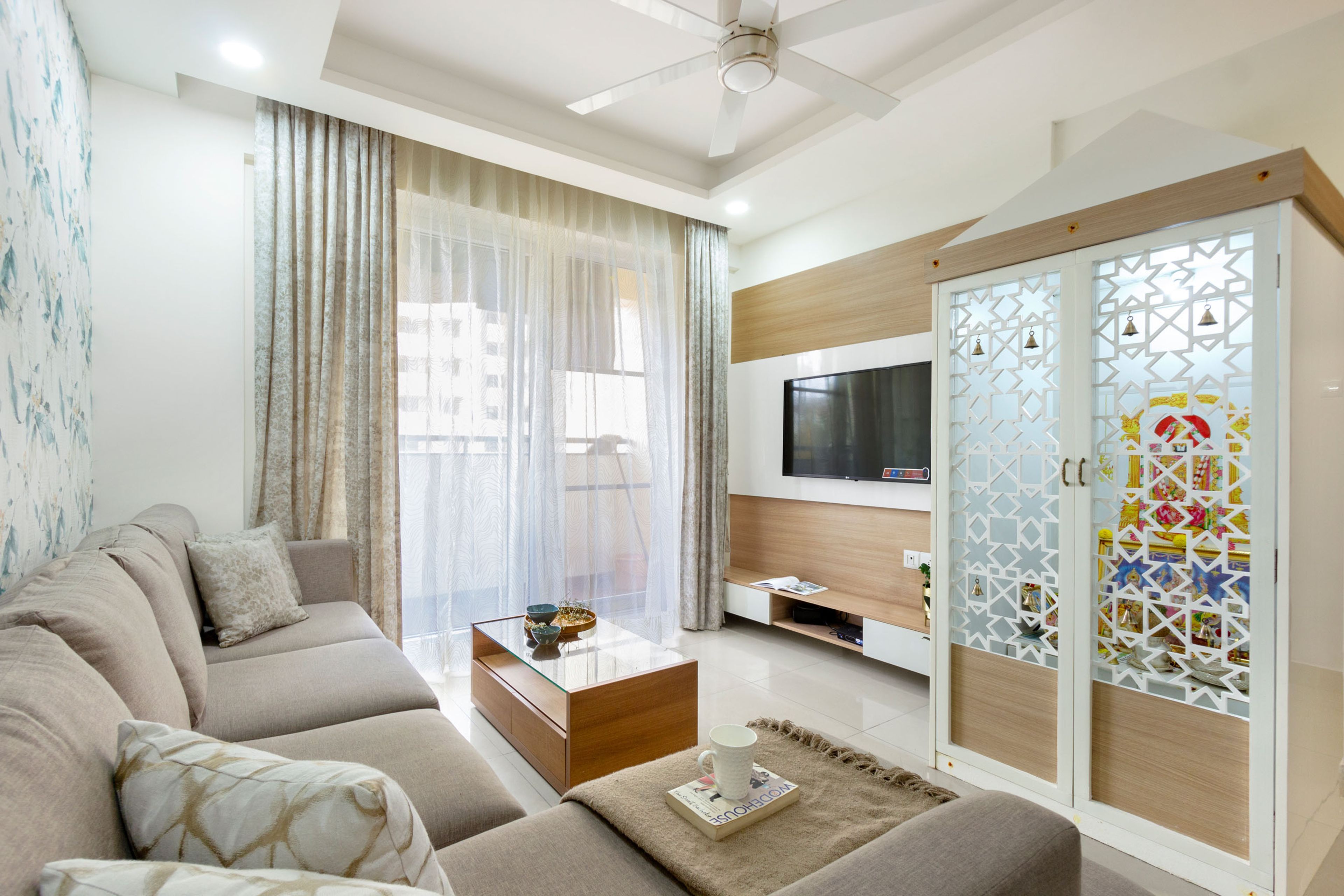 Modern Living Room Design With Sectional Sofa and Pooja Cabinet