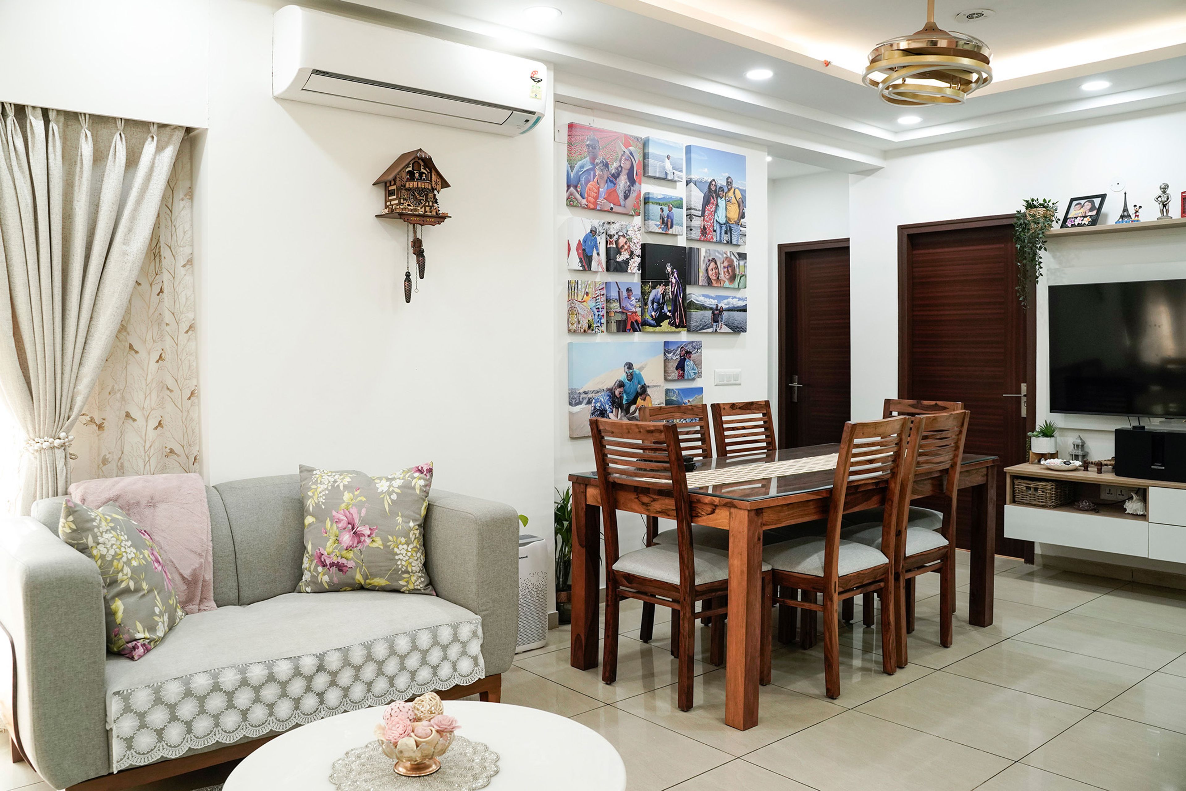 Dining area with wooden table, gallery wall, and soft lighting for a homely feel