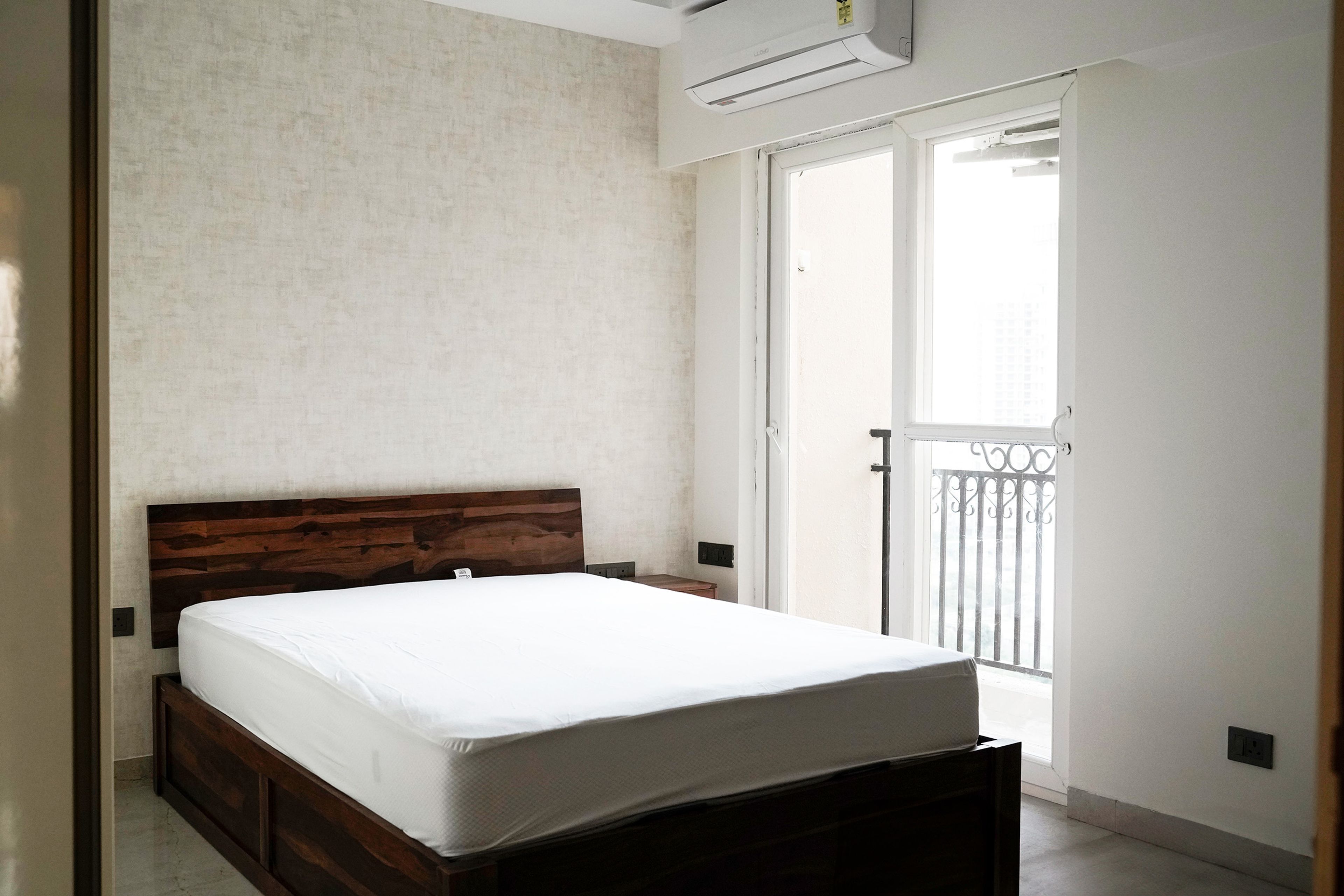 Minimal Guest Bedroom Design Featuring Platform Bed with Built-In Under-Bed Storage