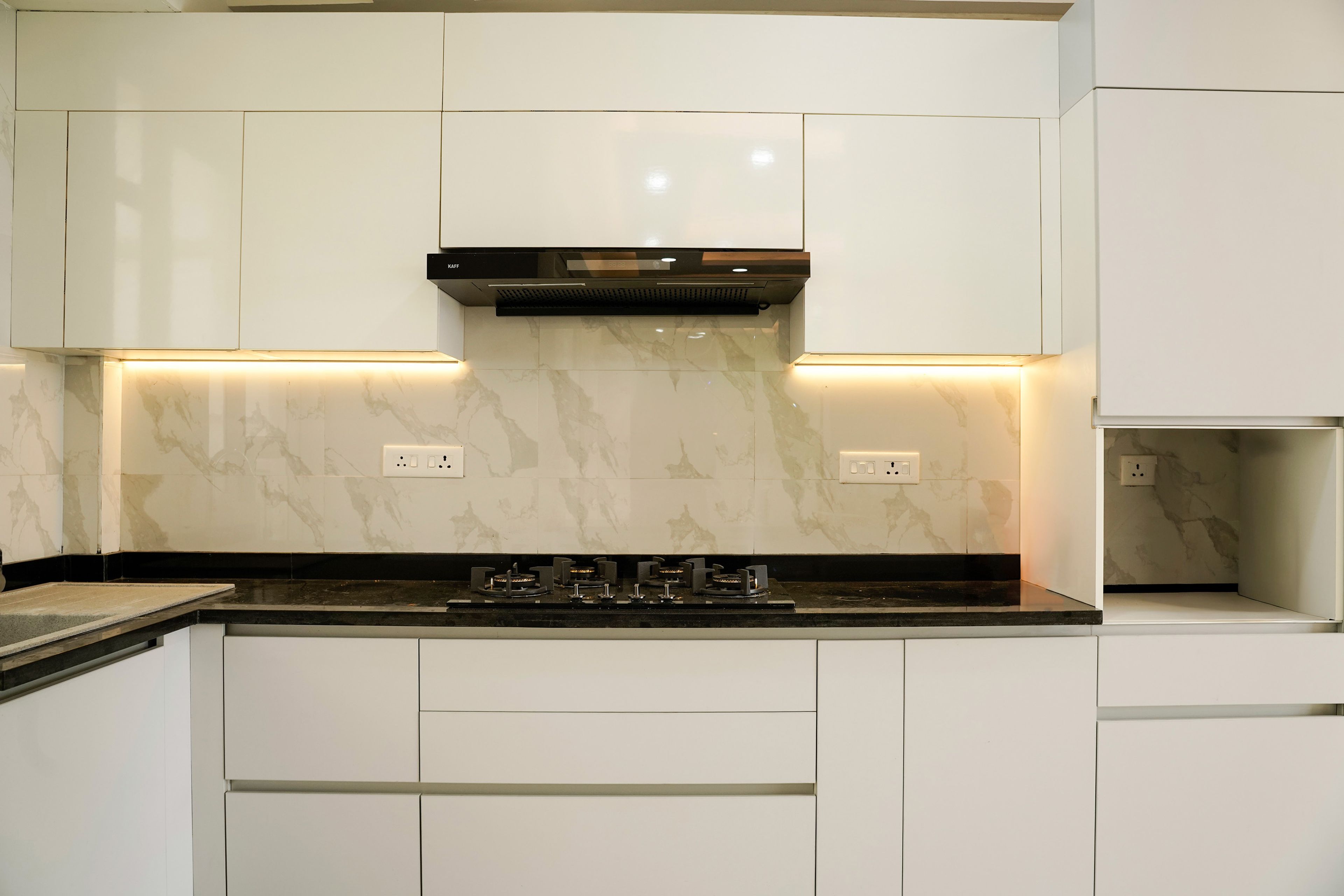 Modern L-Shaped Kitchen Design with White Cabinets and Granite Countertop