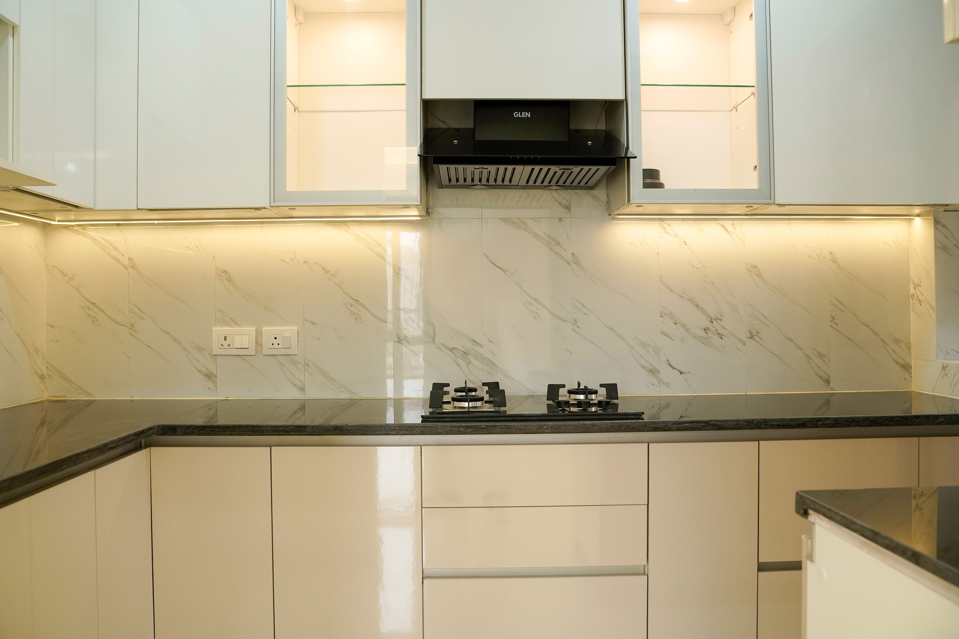 Modern L-Shaped Kitchen Design with Champagne Base and White Wall Cabinets