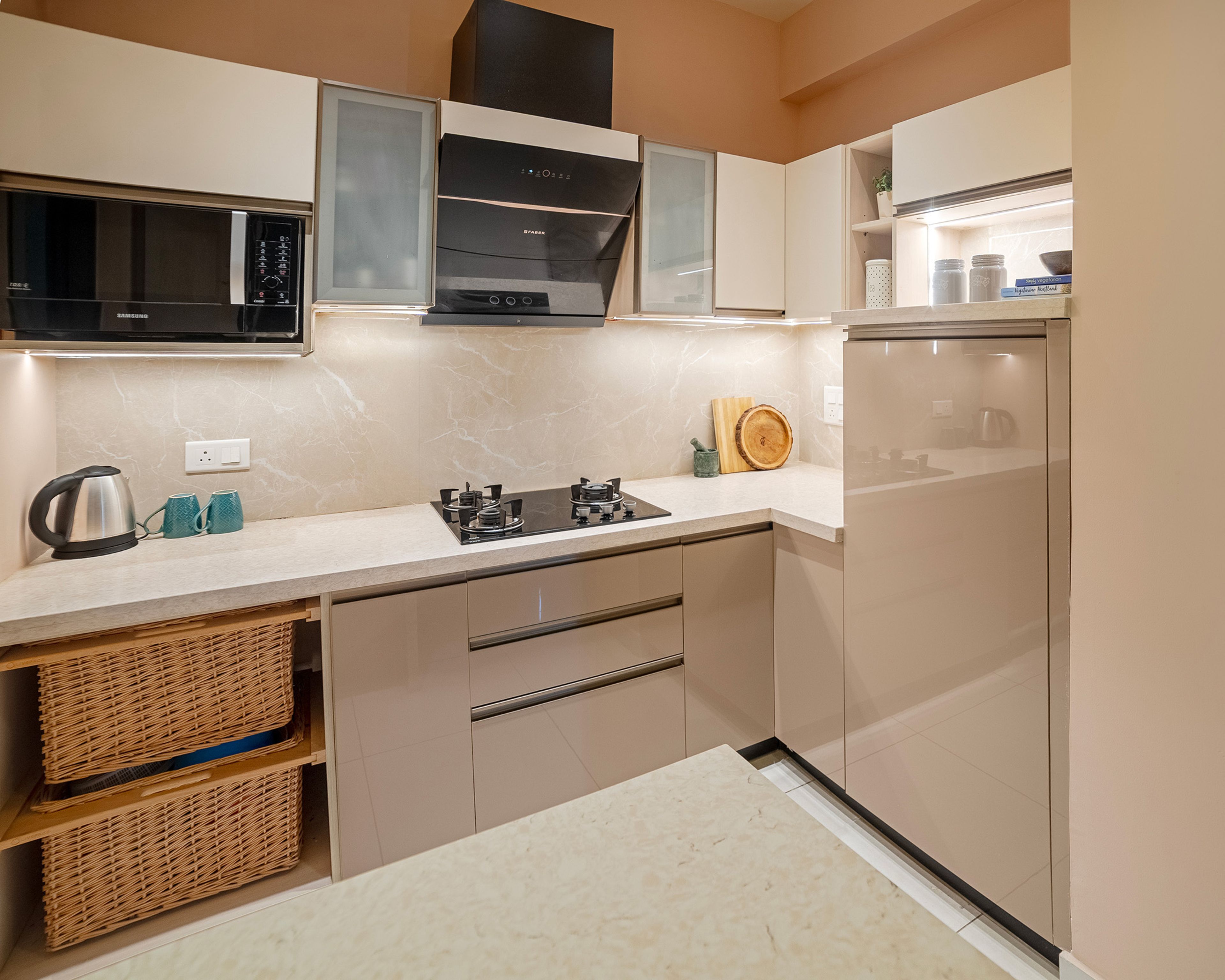 L-Shaped beige kitchen with wicker basket storage and overhead frosted glass cabinets