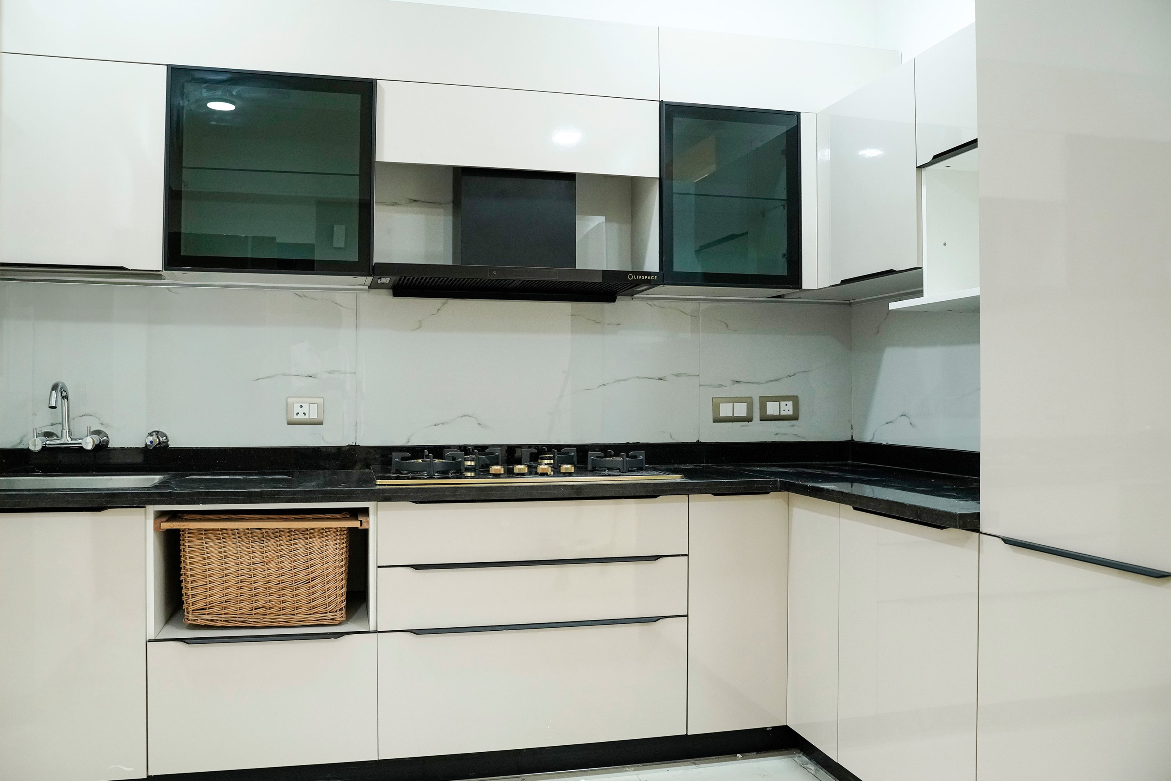 White L-Shaped kitchen with glass front cabinets and dedicated produce basket storage
