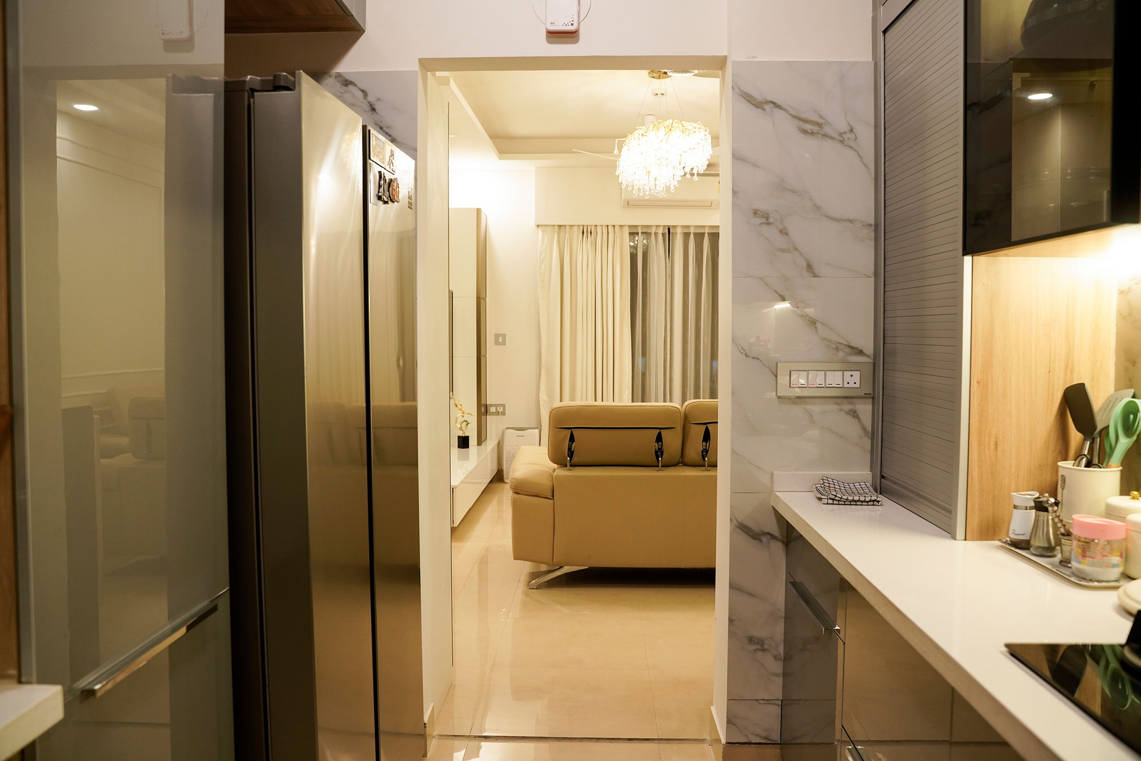 Parallel kitchen with glass upper cabinets, marble backsplash and corner storage