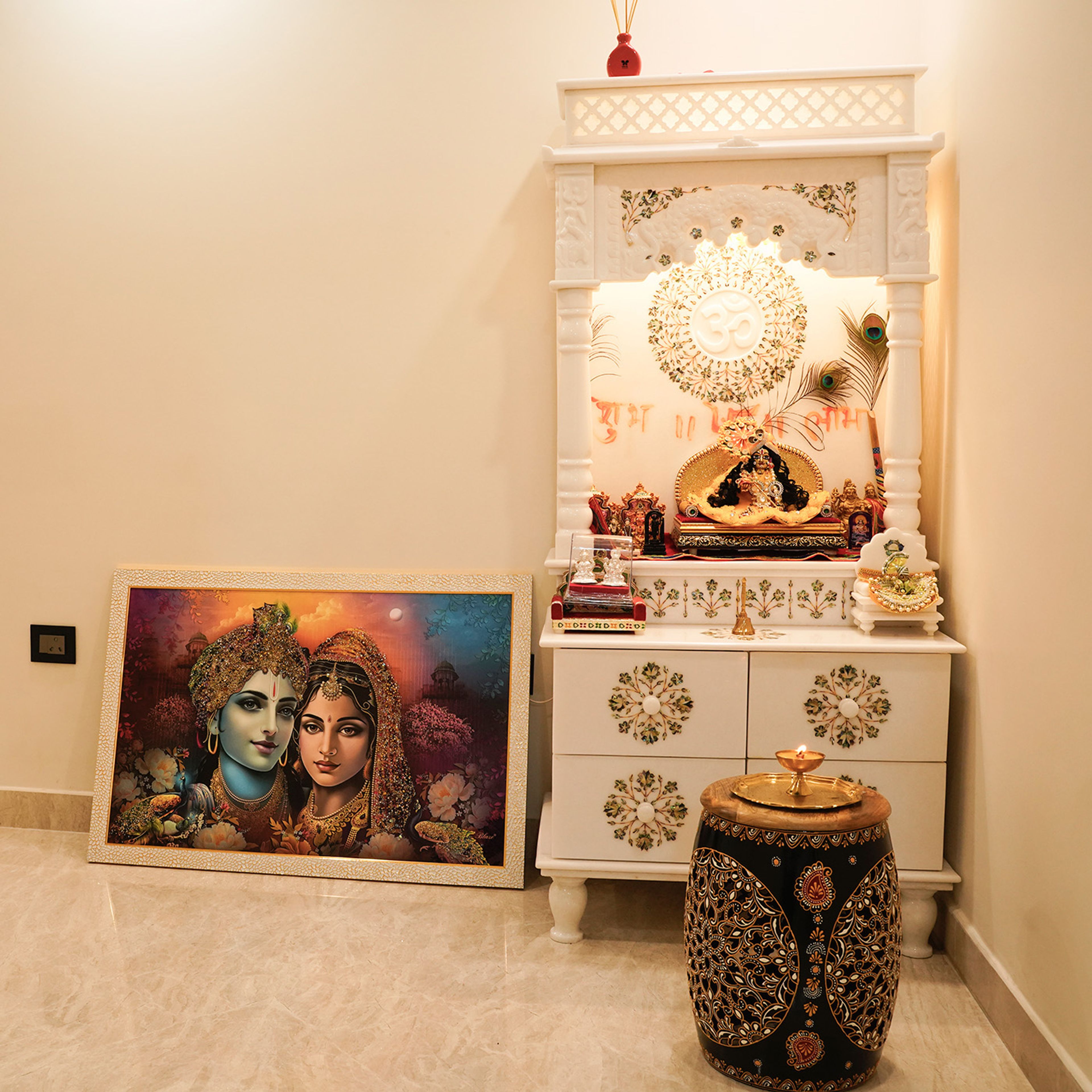 Indian Traditional White Floor Mounted Pooja Room Design with Carvings and Artwork