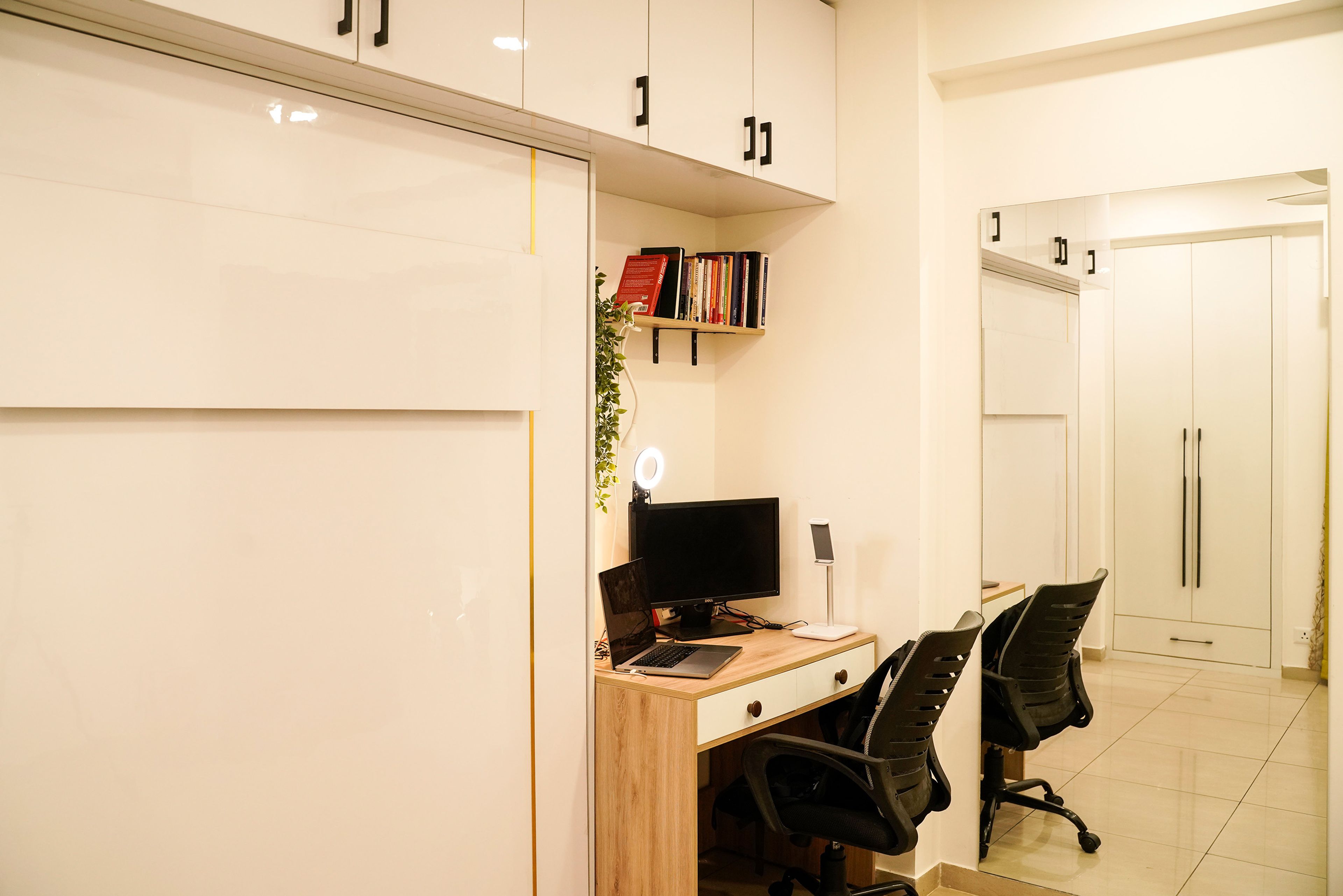 Guest Bedroom Design with Wall-Mounted Storage and Overhead Cabinets