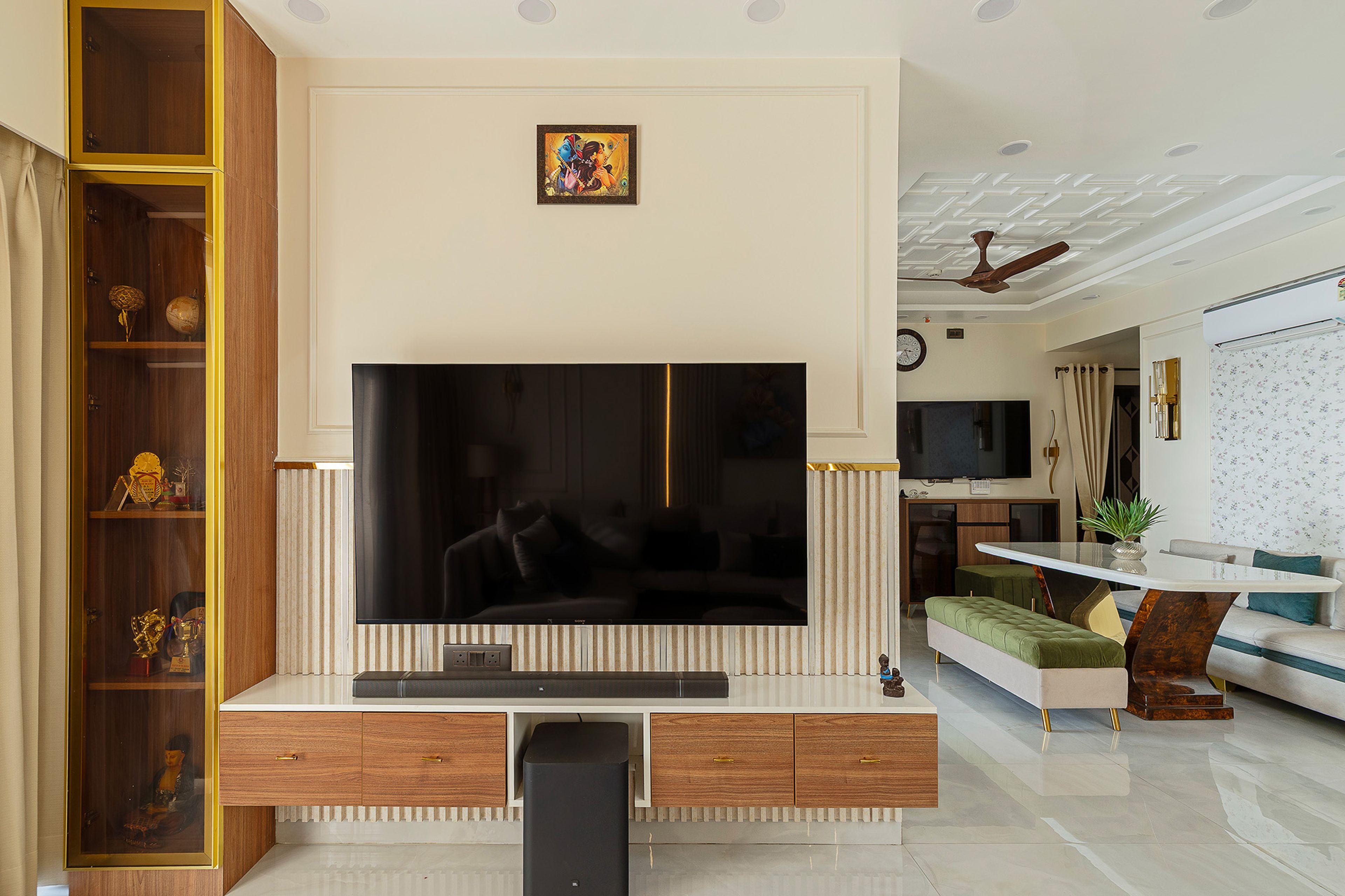 Floating TV unit with gold-trimmed glass display cabinet and fluted panel backdrop