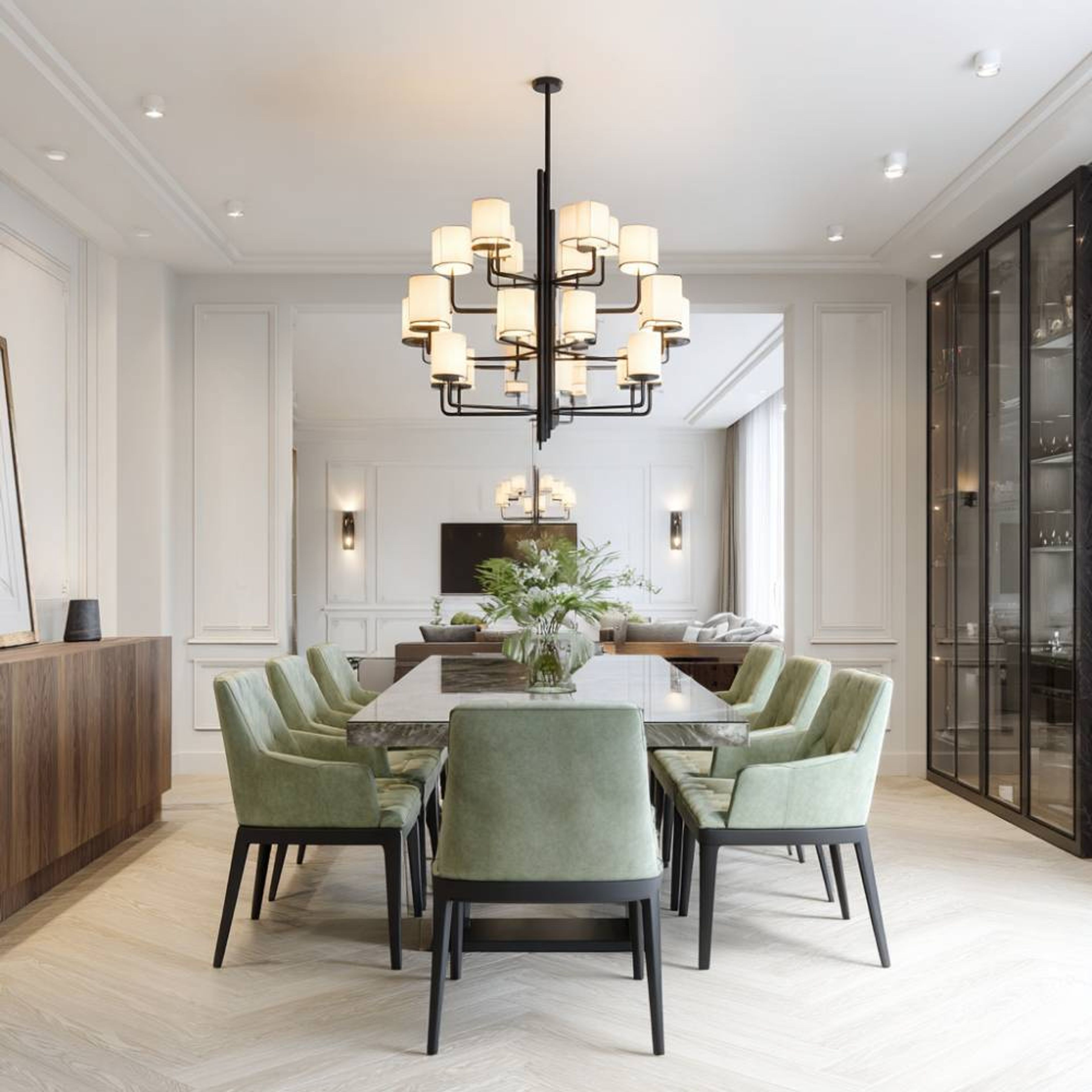 Dining Room Design with Sage Upholstered Chairs, Marble Table and Display Wall