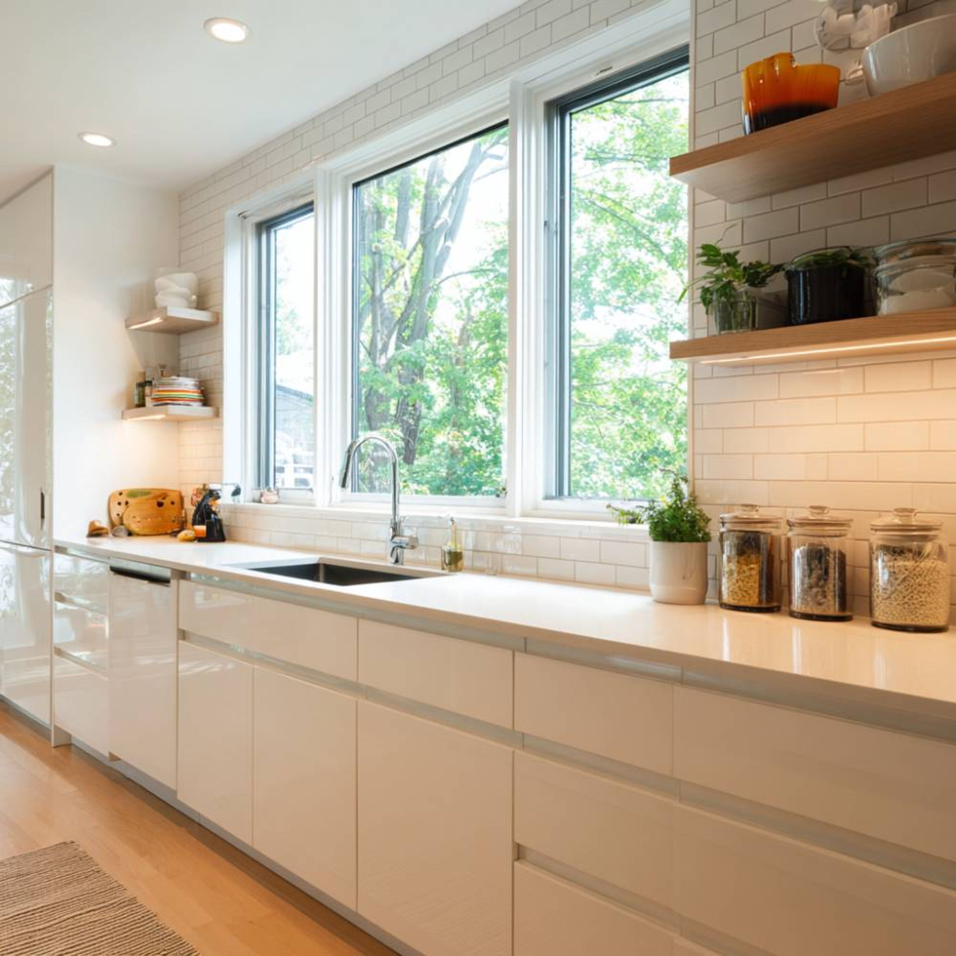 Modern White Open Kitchen Design with Glossy Cabinets and Quartz Counter