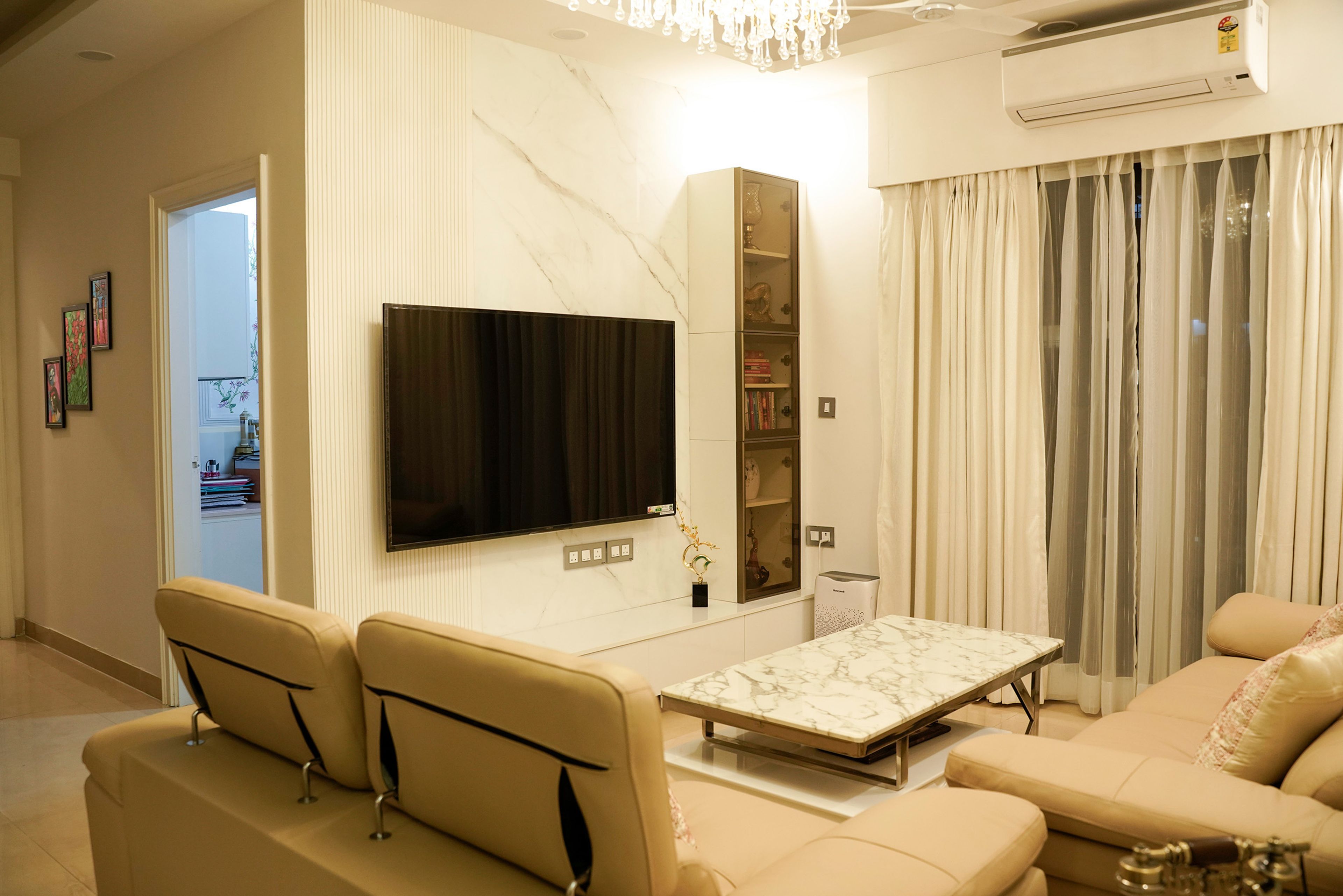Living Room Design with Beige Leather Sofa, Marble TV Wall and Glass Cabinet