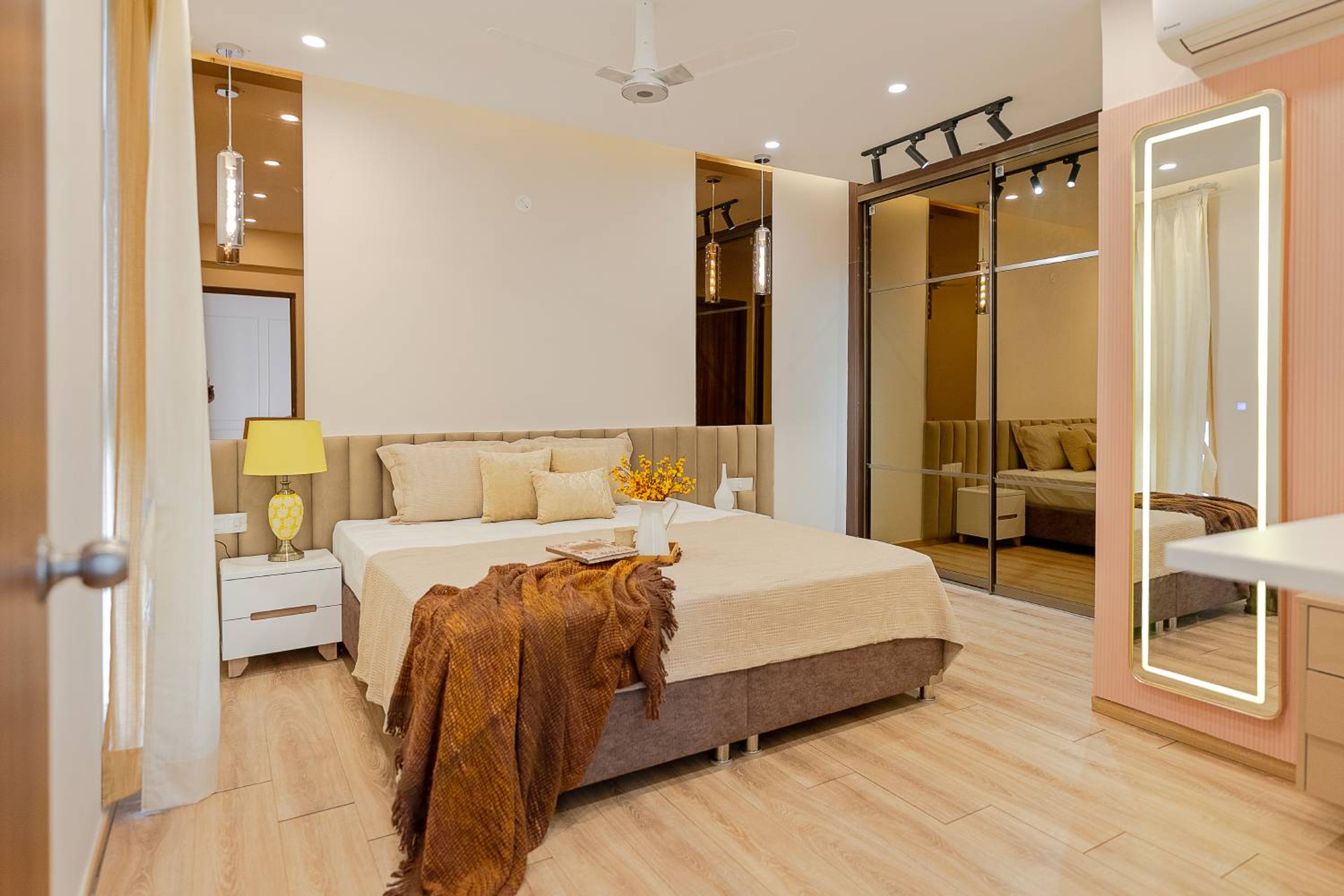 Modern Master Bedroom Design With Mirrored Wardrobe and Padded Headboard Bed