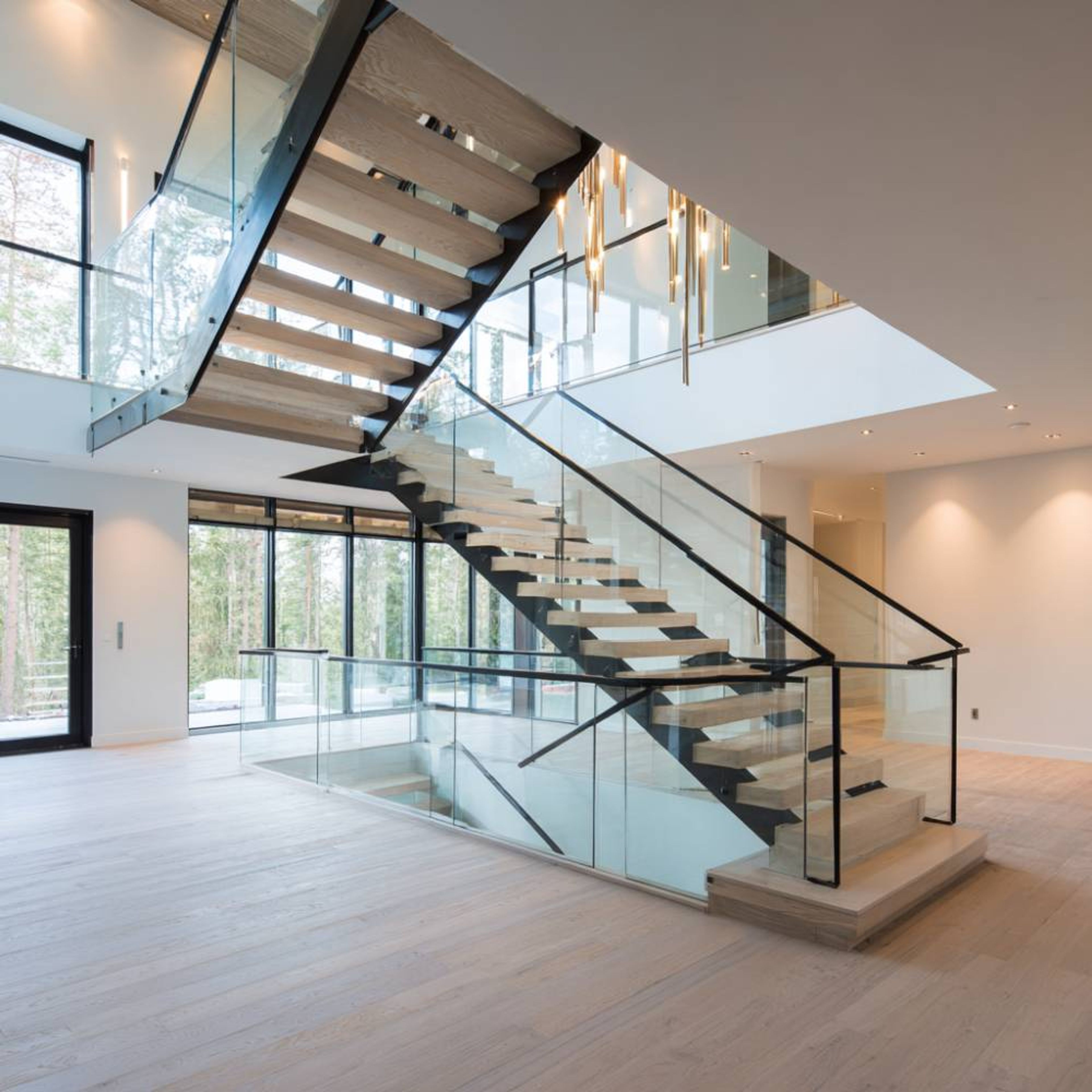 Modern L-Shaped Staircase Design with Glass Railings and Wooden Steps