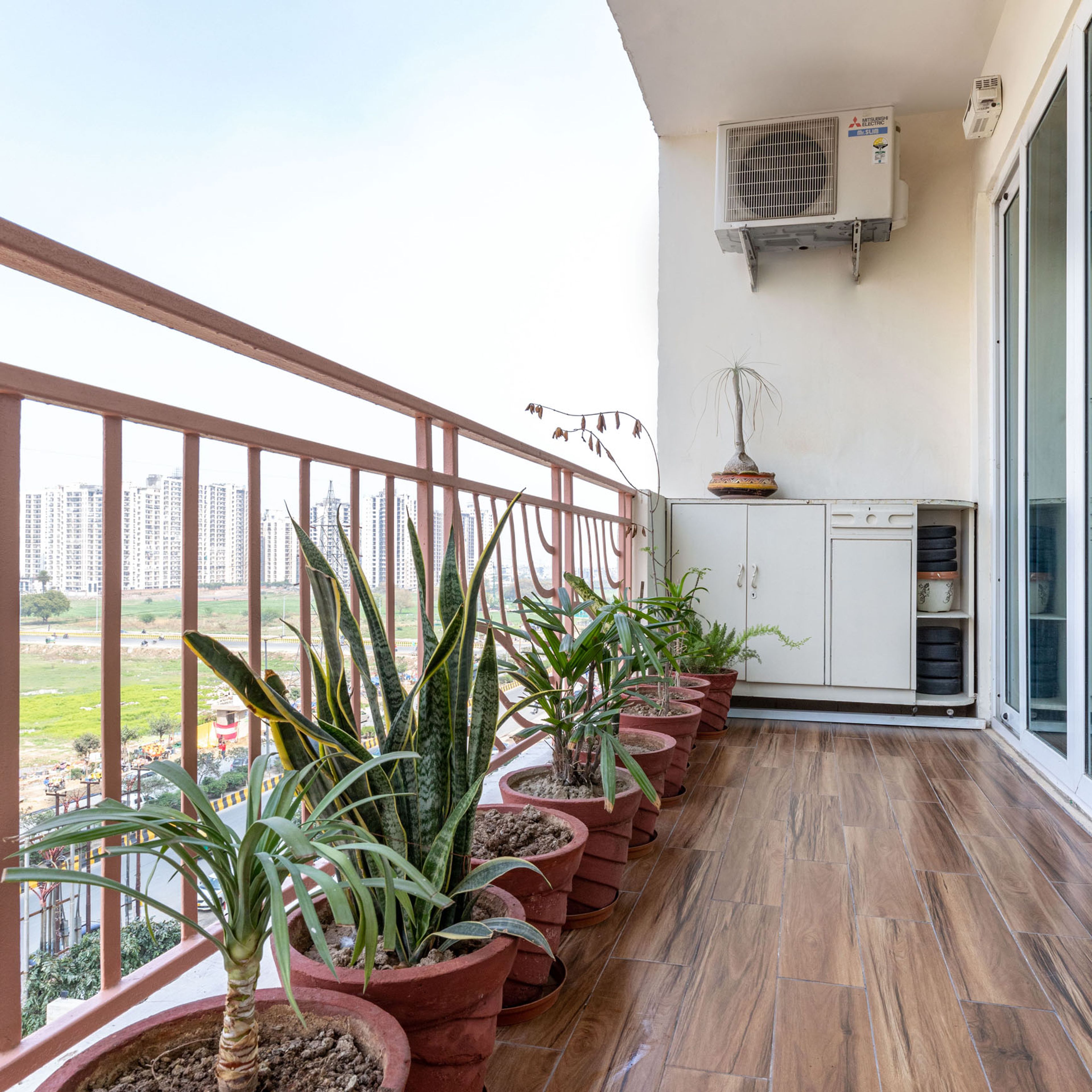 4X8 Ft Balcony Design With Wooden Flooring And Storage Unit - Livspace