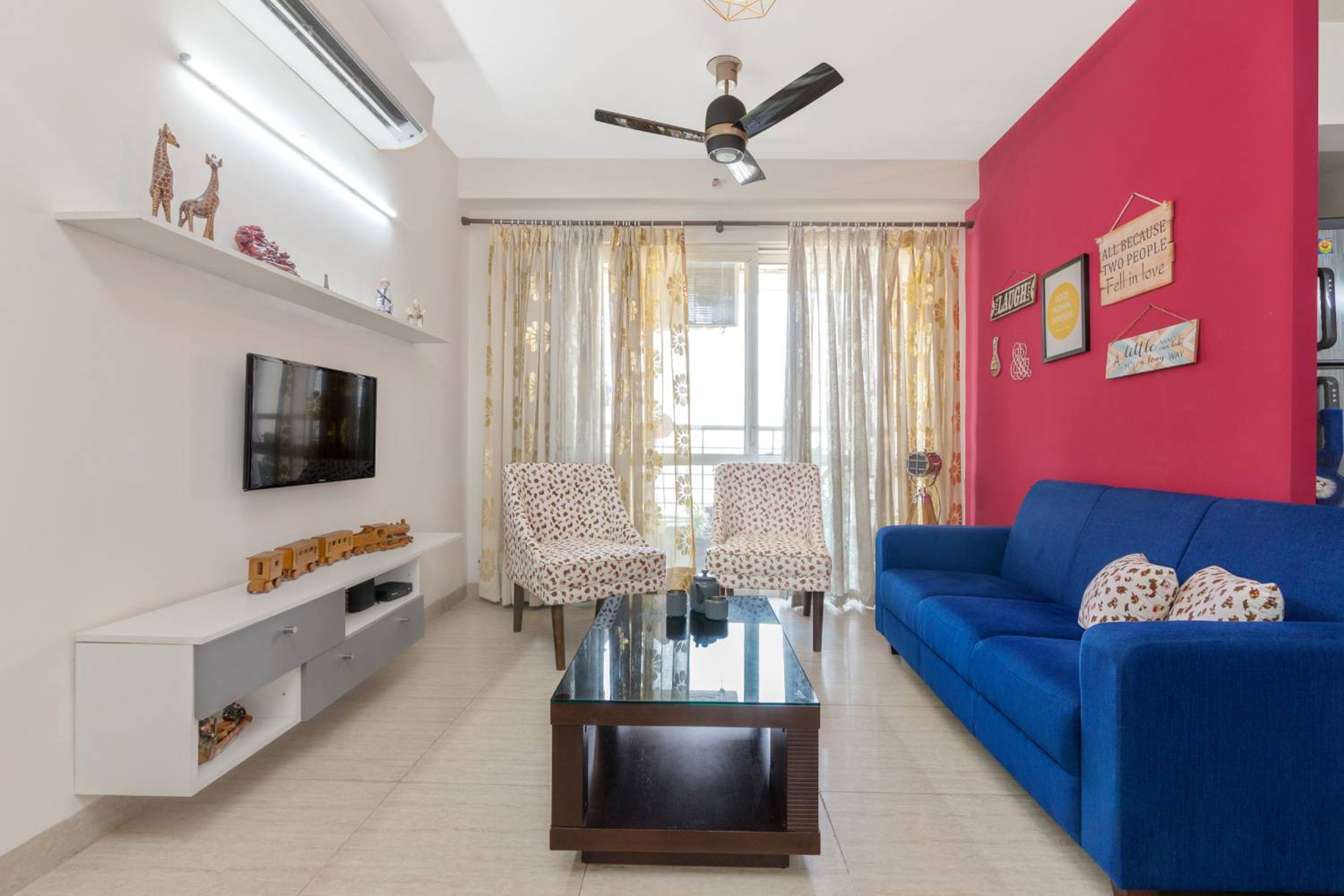 Living Room Design with Blue Sofa and White TV Unit