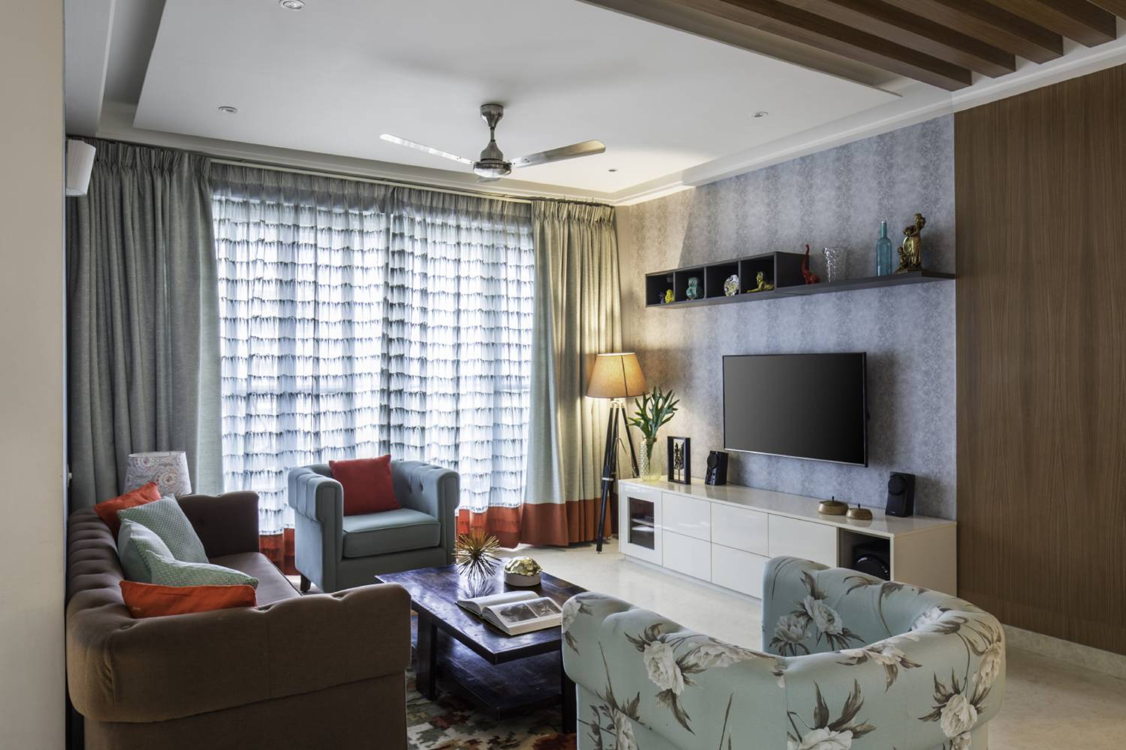 Living Room Design with Brown Sofa and Blue Chairs