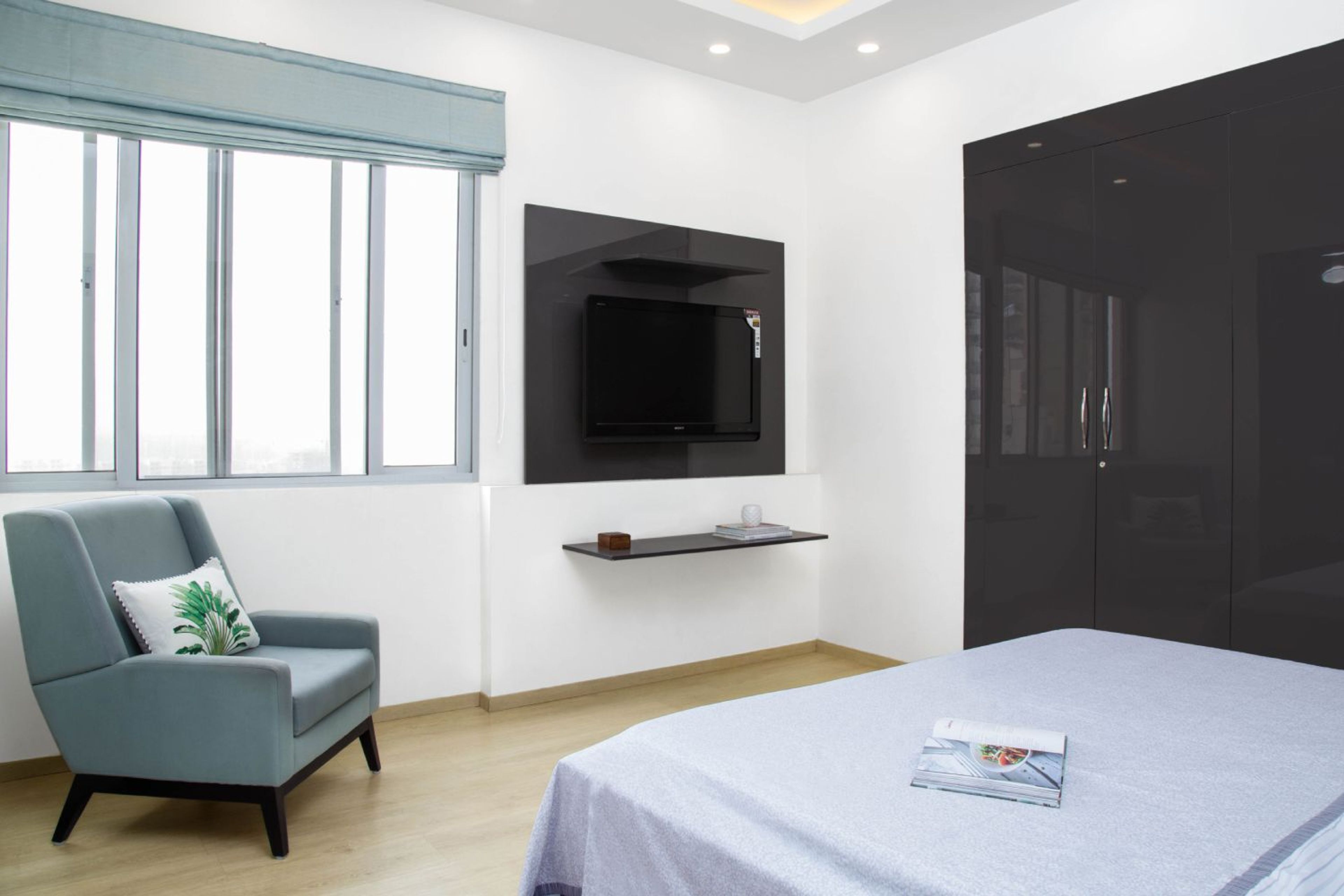 Guest Bedroom Design with Blue Accent Chair