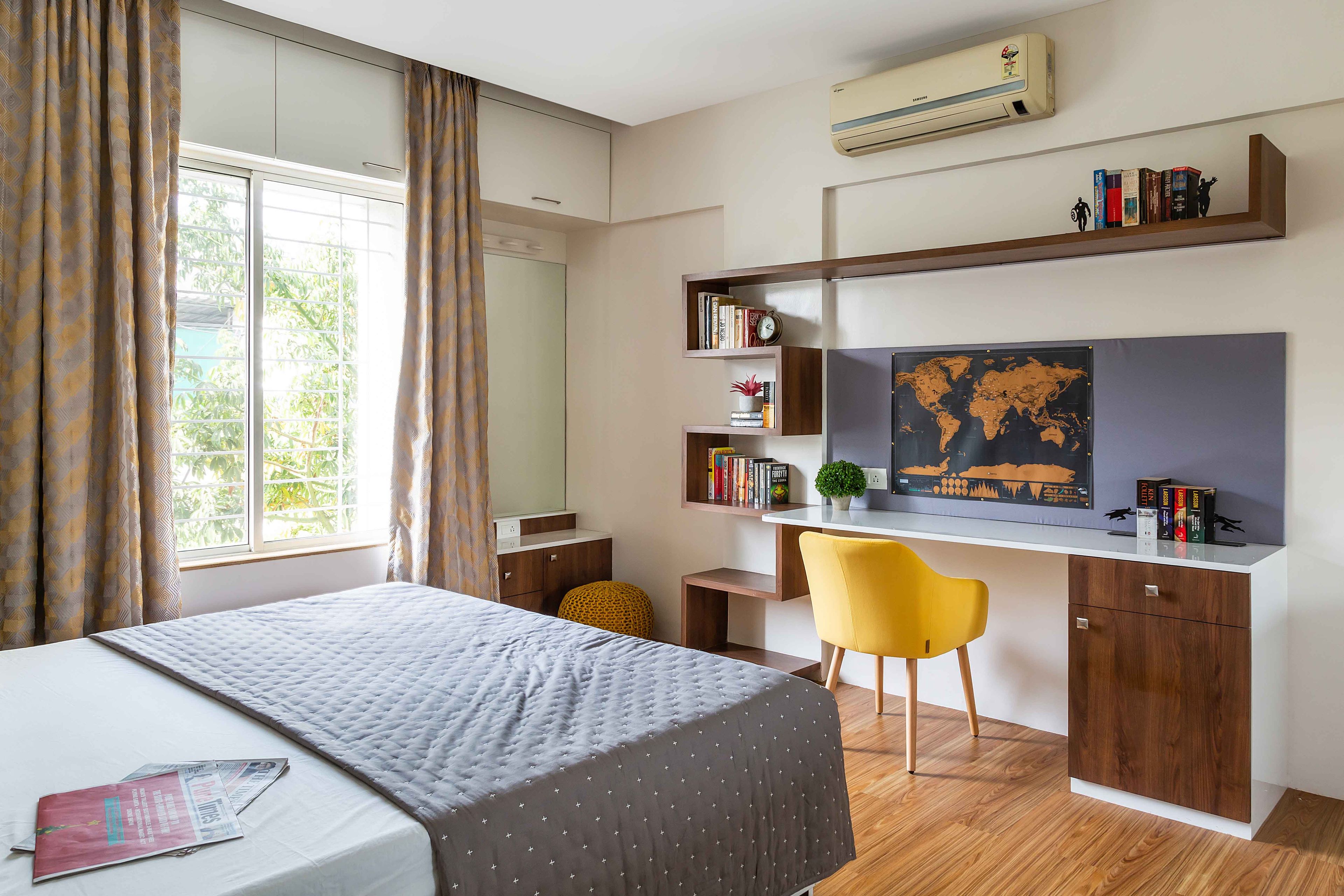 Minimalist Guest Room Design With Grey Queen Bed, Chevron Wallpaper, Mirrored Wardrobe, and Yellow Accent Chair - Livspace