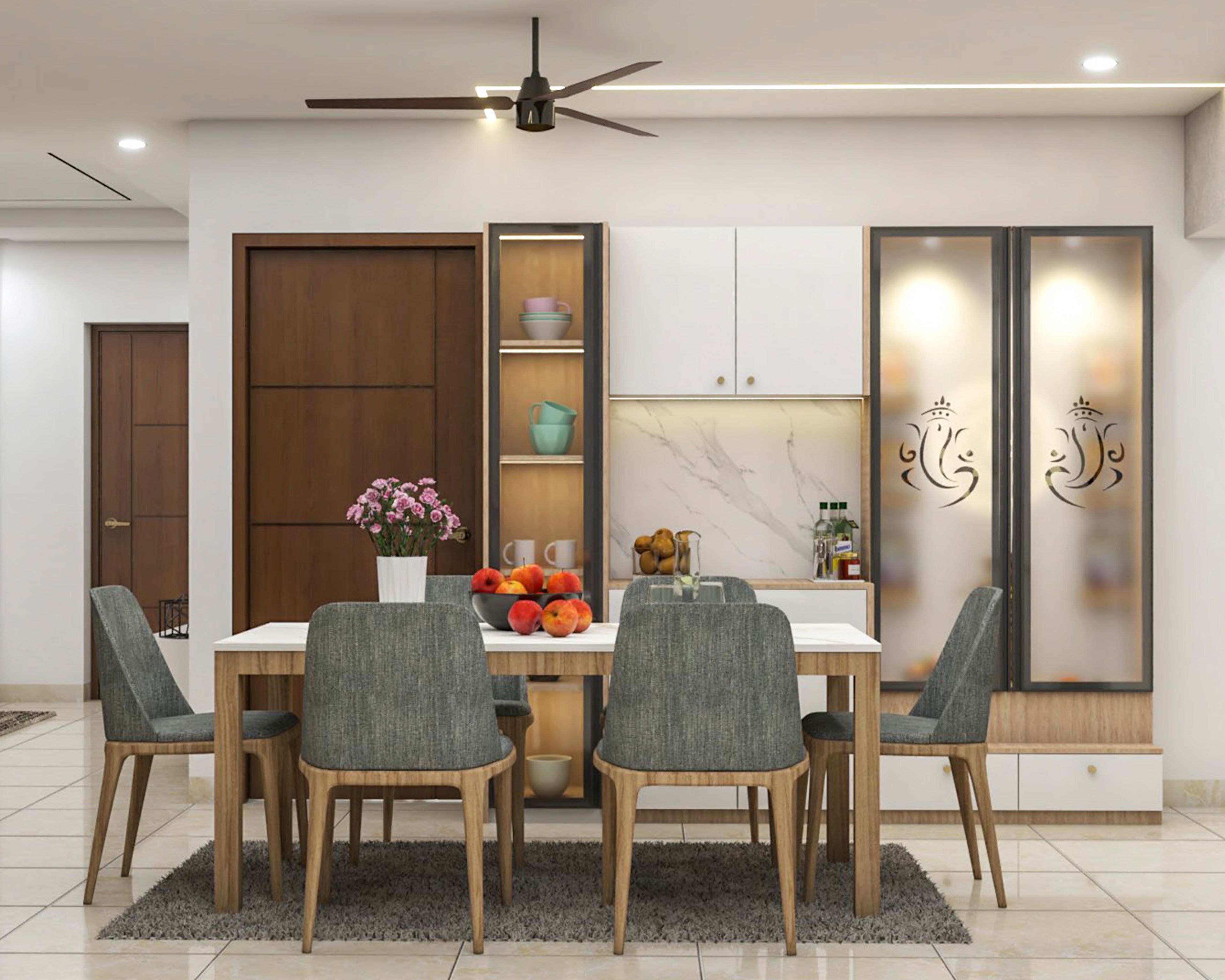 Dining room design with 6-seater white table, grey chairs, and crockery units and pooja unit - Livspace