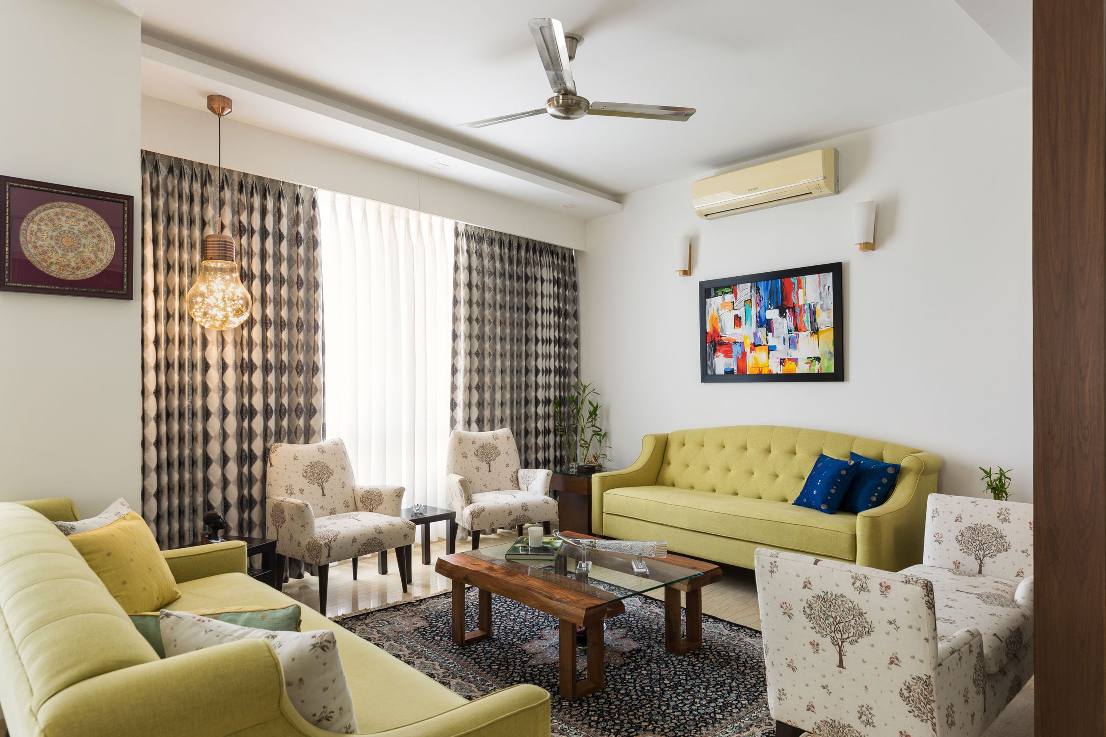 Modern Living Room with Parallel Yellow Chesterfield Sofas, White Patterned Seater, and Rectangle Coffee Table - Livspace